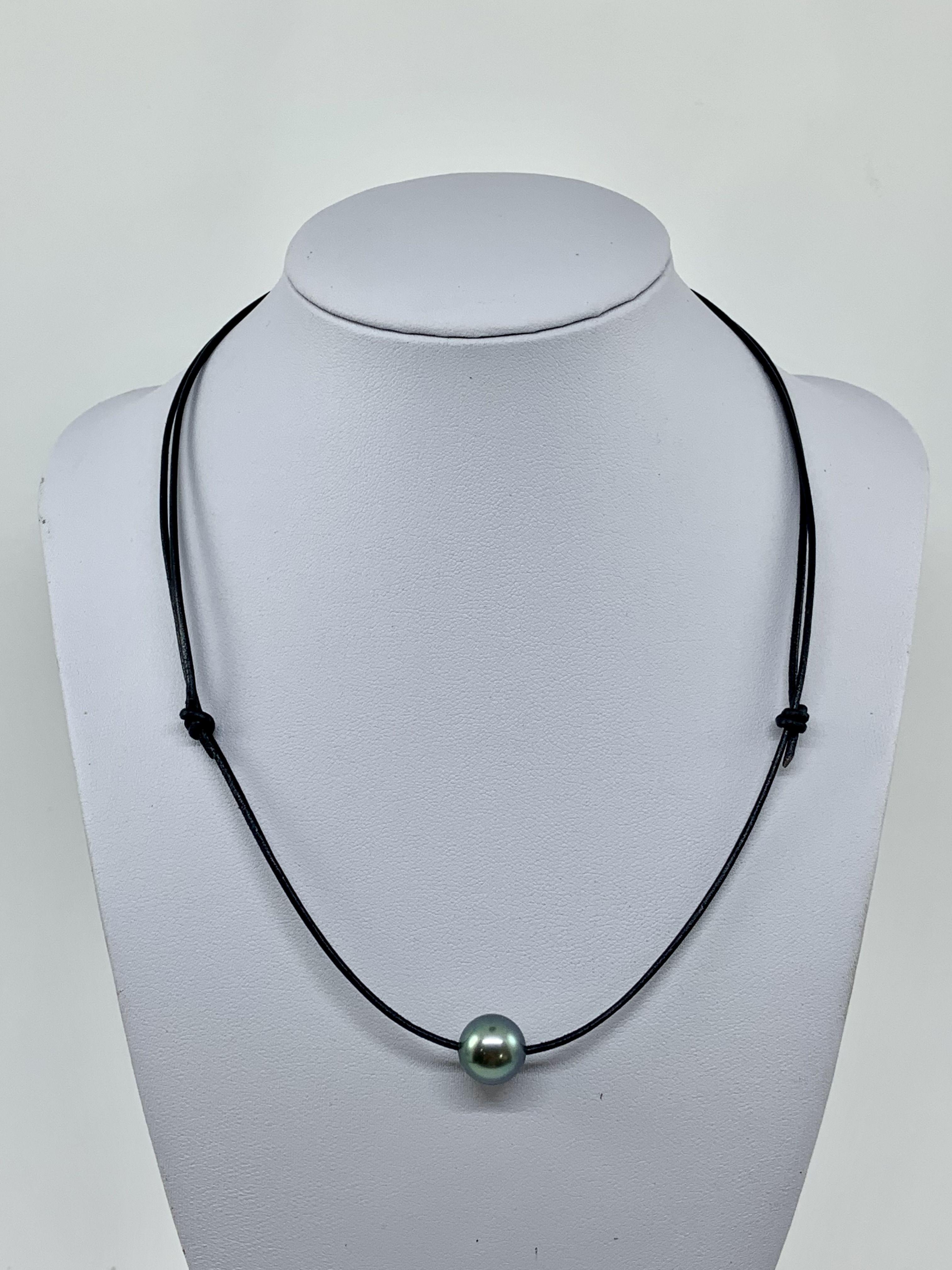 Simply Beautiful! Tahitian Pearl on Leather Cord Necklace. Hand set with an 11.1mm Tahitian Pearl, reflects Blue Gray; on a Hand-crafted Leather cord approx. 1.6mm thickness. The necklace measures approx. 18” long. More Beautiful in real time!