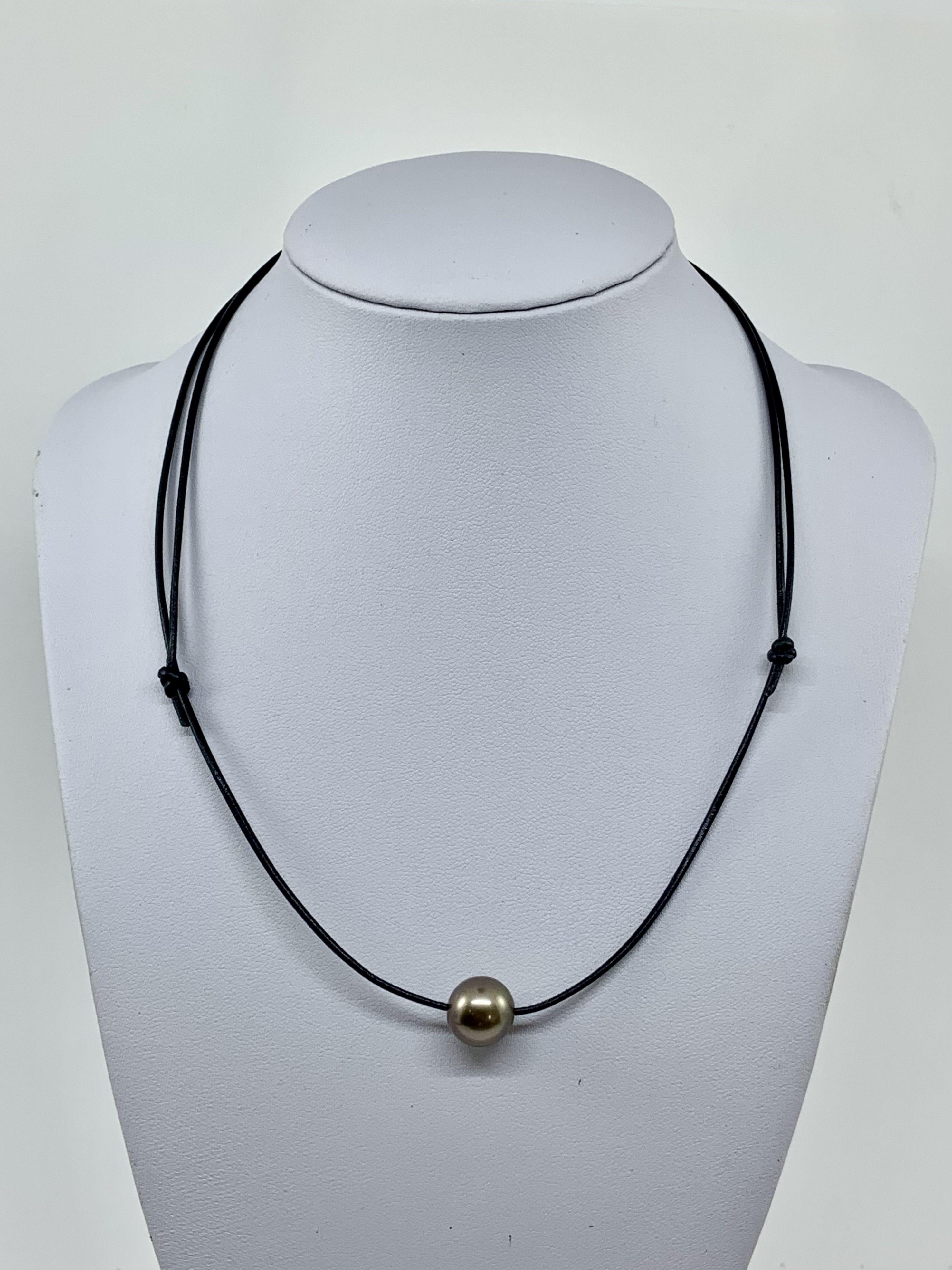 Simply Beautiful! Tahitian Pearl on Leather Cord Necklace. Hand set with an 11.1mm Pearl on a Hand-crafted Leather Cord of 1.6mm thickness. The necklace measures approx. 18” long. More Beautiful in real time! Classic and Chic...A piece you’ll turn