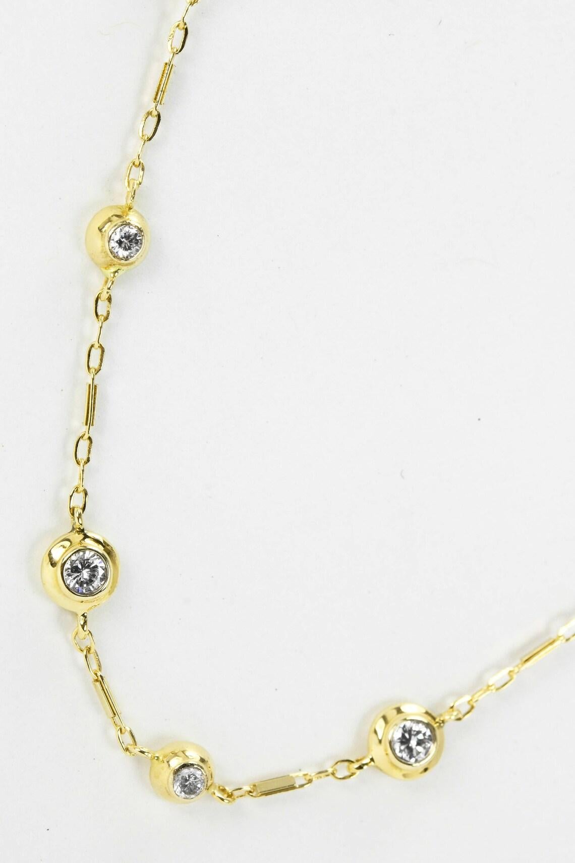 Displayed is a magnificent diamond by the yard necklace. This classic necklace is both timeless and elegant and will be sure to add that something special to any outfit, anytime! The chain includes twenty-one round, bezel set encrusted diamonds,