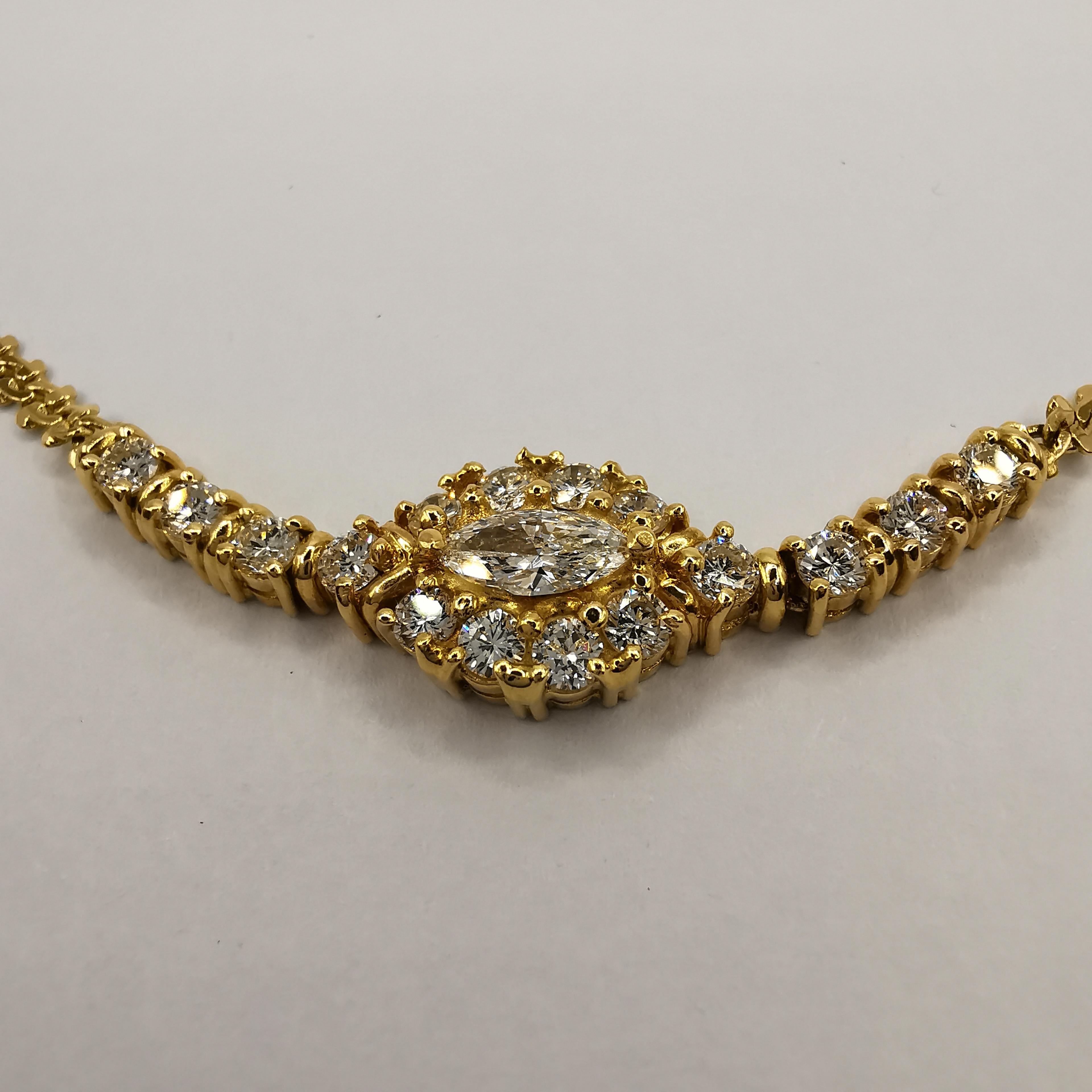 This stunning 112 carat marquise diamond choker necklace is the perfect accessory for any special occasion. The centerpiece of the necklace features a single, sparkling marquise cut diamond weighing 0.26 carats, surrounded by 16 brilliant round cut