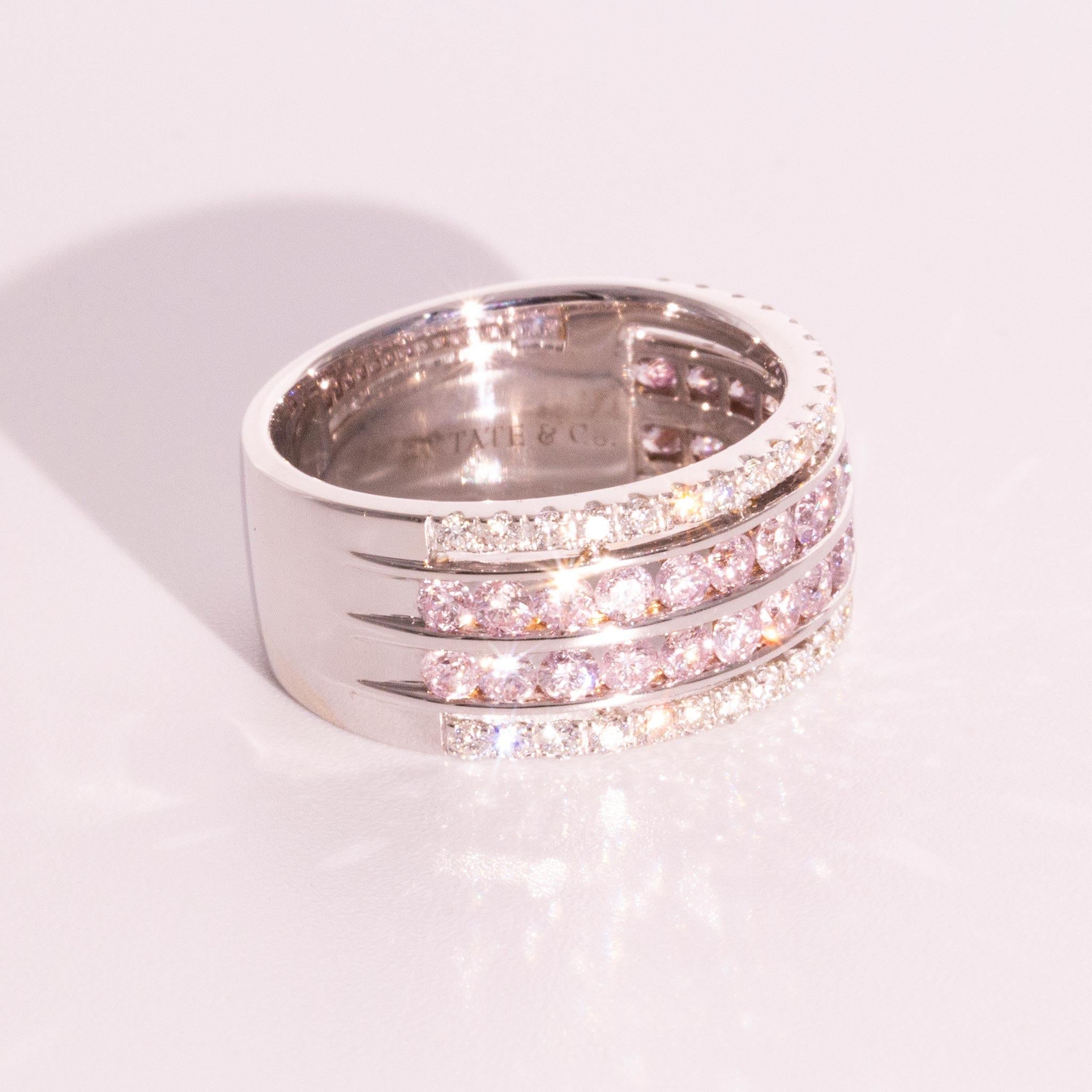Carefully crafted in 18 carat white gold is this breath taking ring featuring two glittering rows of 1.12 carats of channel set soft natural pink diamonds with a further 0.40 carats of shining white diamonds at the ring edges. We have named this