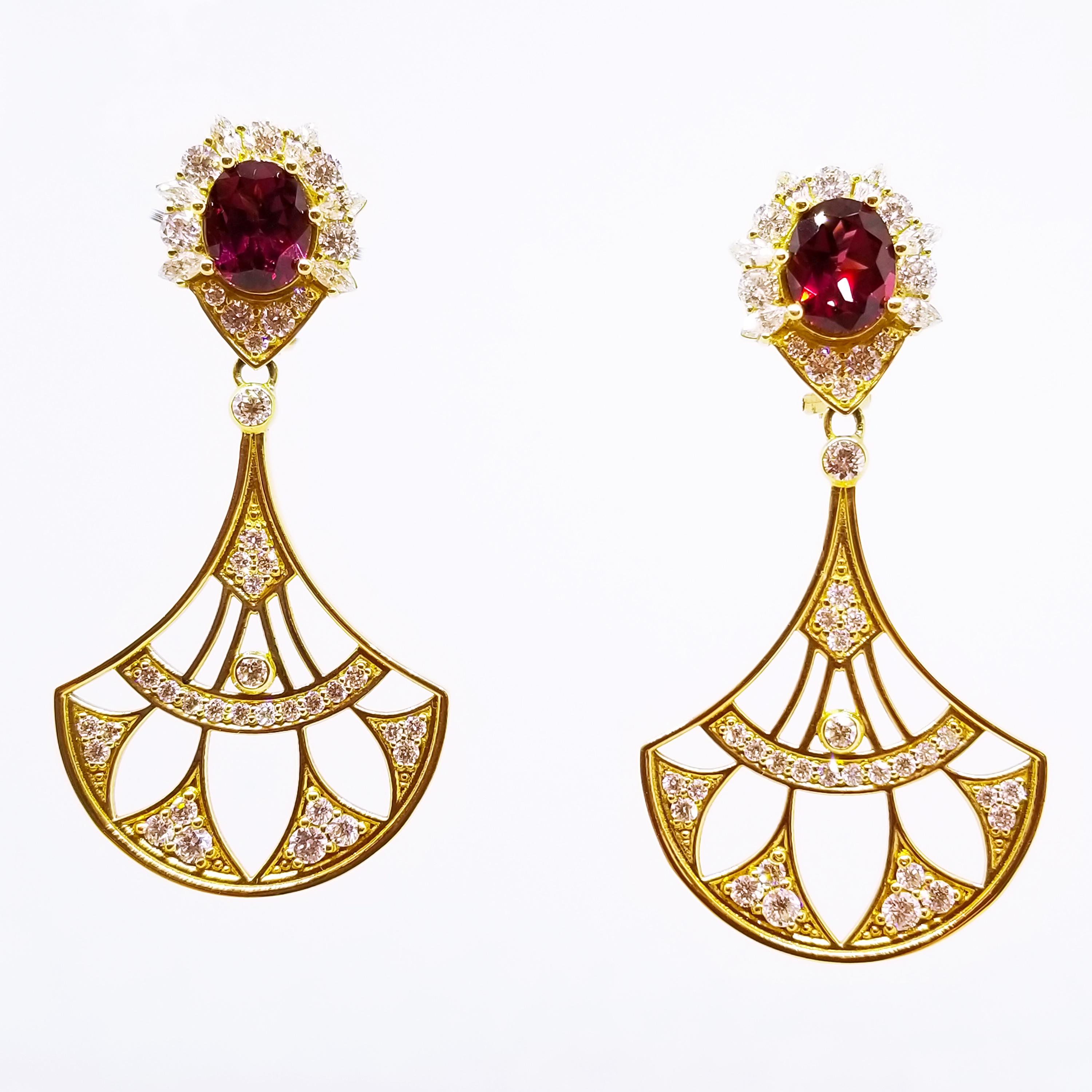 These Long and Elegant Statement Earrings are One of a Kind in 18K Yellow Gold. The Dramatic Earrings feature faceted, Oval Rhodolite Garnets of Intense Red Hue and Gem Quality. Each Gemstone measures 10 x 8mm and the two stones combine for a total