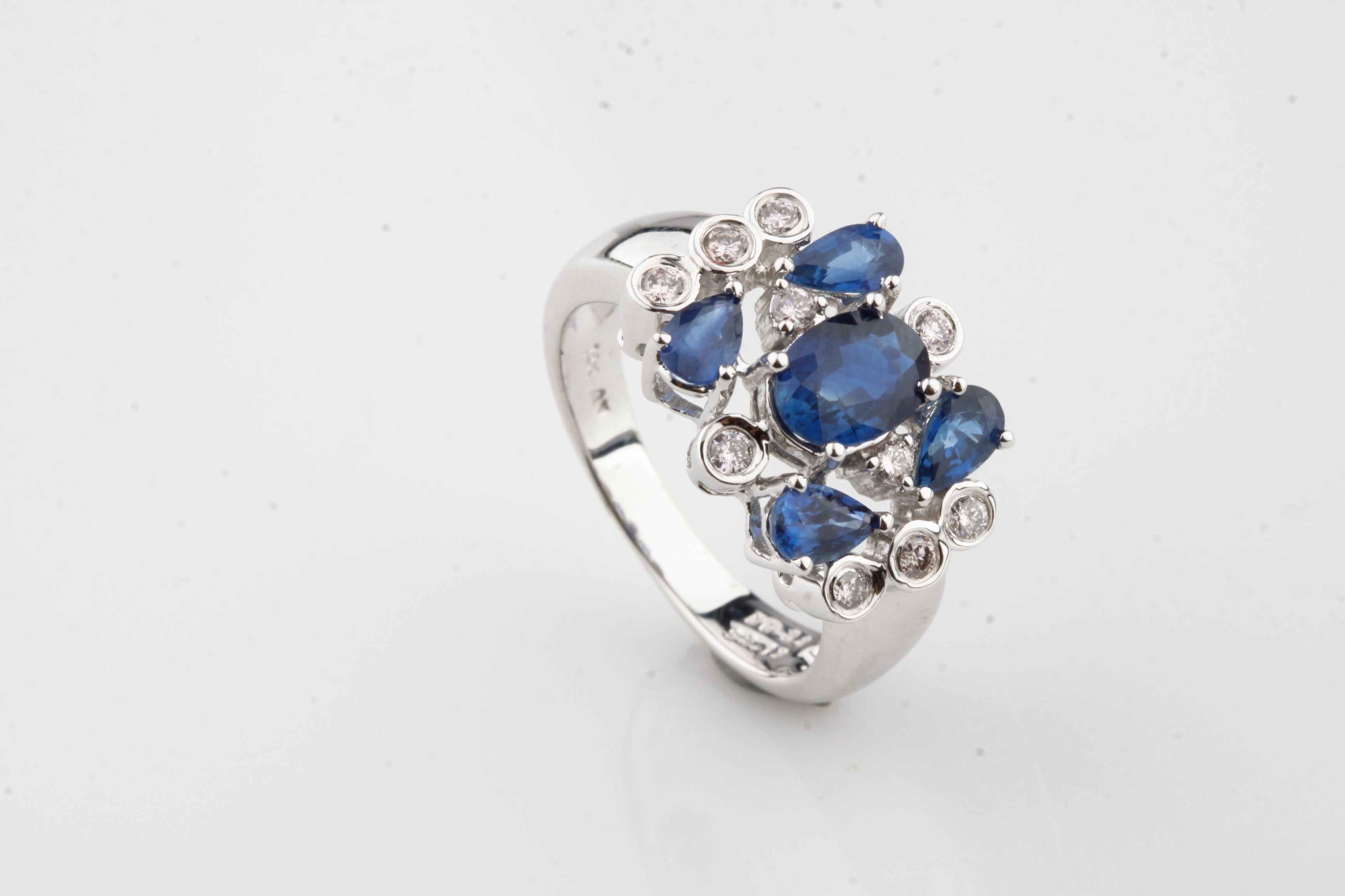 One Electronically tested 14k white gold ladies cast sapphire & diamond cluster ring with a bright finish. Condition is new, good workmanship. Trademark is An. Identified with markings of 