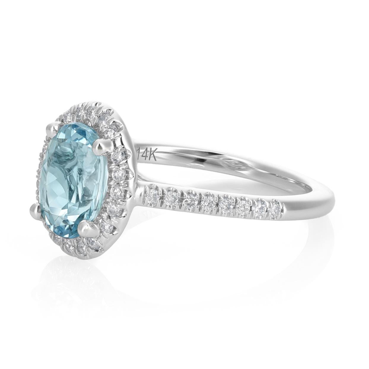 Embrace elegance with this 14K White Gold Ring featuring a 1.12 carats natural Aquamarine in a graceful oval shape. The soothing blue hue of the Aquamarine is enhanced through a heating process, adding depth to its allure. Surrounding the