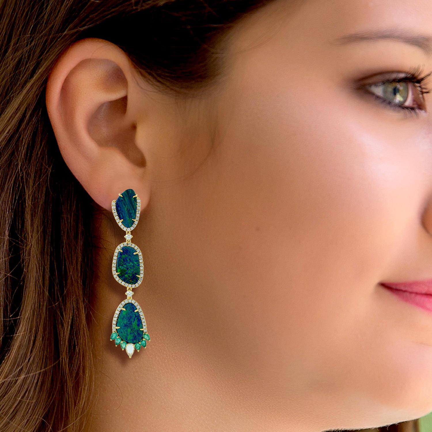 Cast in 18 karat gold. These stud earrings are hand set in 11.2 carats opal doublet, .84 carats emerald and 1.28 carats of sparkling diamonds. 

FOLLOW MEGHNA JEWELS storefront to view the latest collection & exclusive pieces. Meghna Jewels is