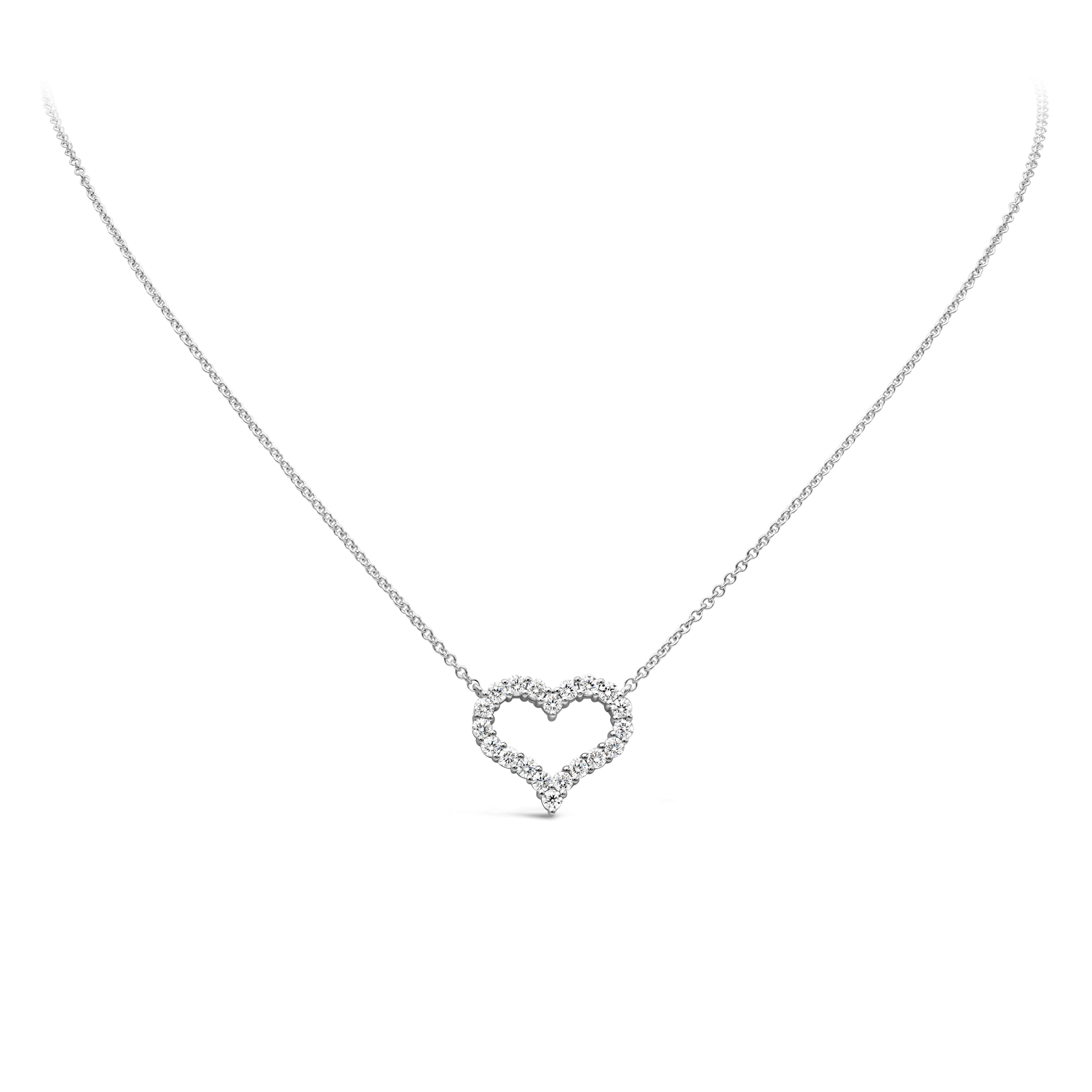 A simple and unique pendant necklace showcasing a row of round brilliant diamonds weighing 1.12 carats total, F color and VS/SI1 in clarity. Set in an open-work heart shape mounting made in 18K white gold and shared prong setting. Suspended on an 18