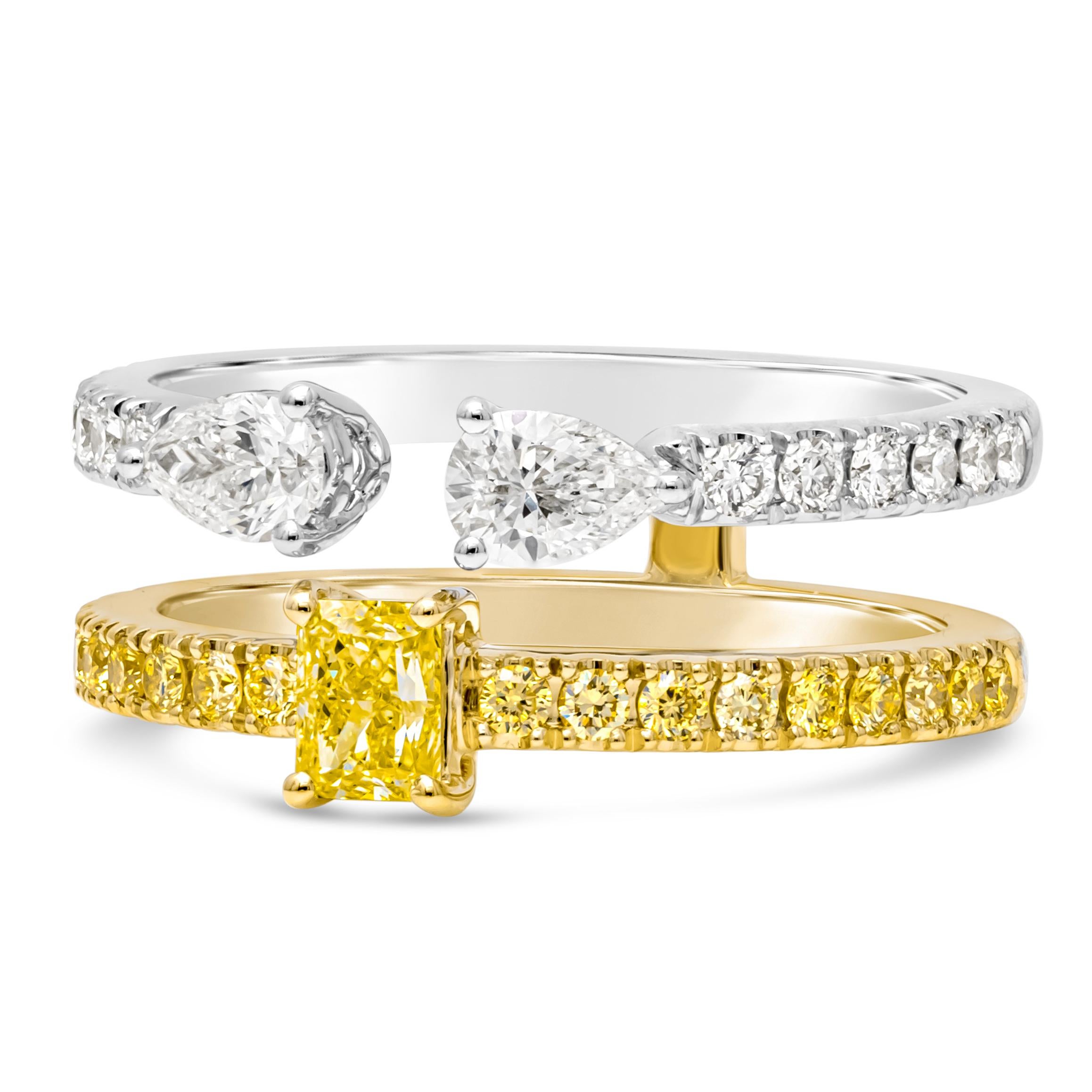 This exquisite double band fashion ring features a stunning combination of elegance and vibrancy. One band showcases fancy color emerald cut diamond center stone, accented with pave round fancy color diamonds, set in a 18k yellow gold. While the