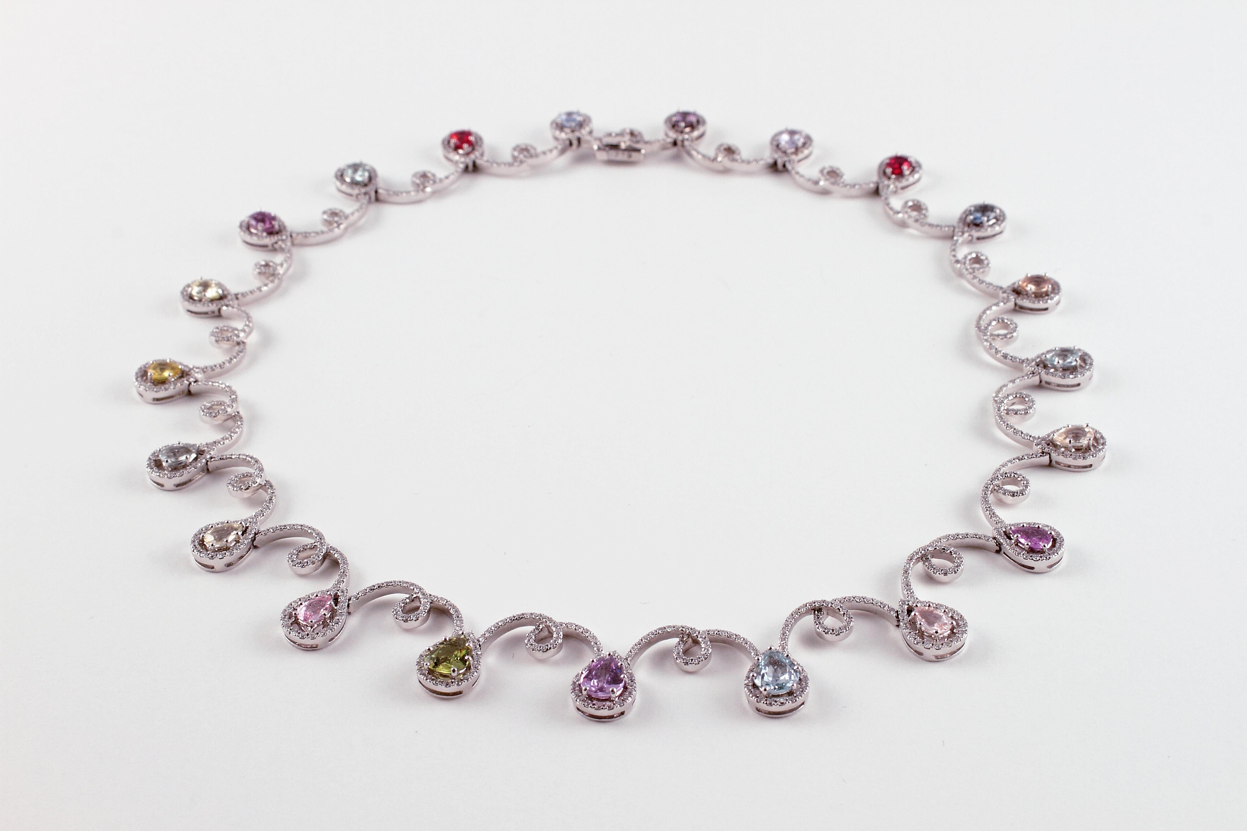 Such a lovely and elegant necklace!  In 18 karat white gold, purchased from famed London designer David Morris, this beauty supports twenty-one pear-shaped sapphires in various colors, with a stated total weight of 11.12 carats along with a delicate