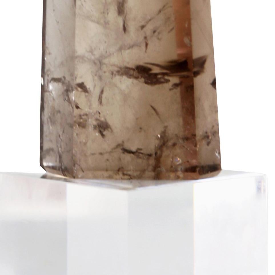 Smoky Quartz Point on Plexiglass Stand is a unique and natural contemporary design piece that is smokey brown on clear plexiglass and measures 6.5 x 3 and is priced at $355. 
