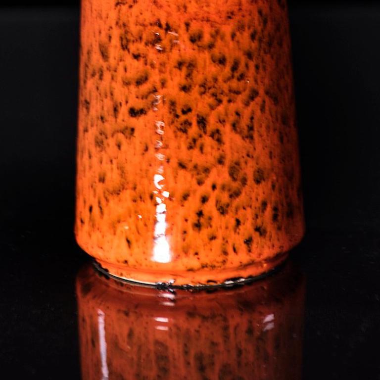 This mid century modernist vase by Ruscha Keramik features a sophisticated speckled orange glaze that highlights its modern silhouette.

Orange Modernist Vase
Ruscha Keramik
c. 1960s

Height: 9.84 inches / 25 cm

Markings:
848, raised