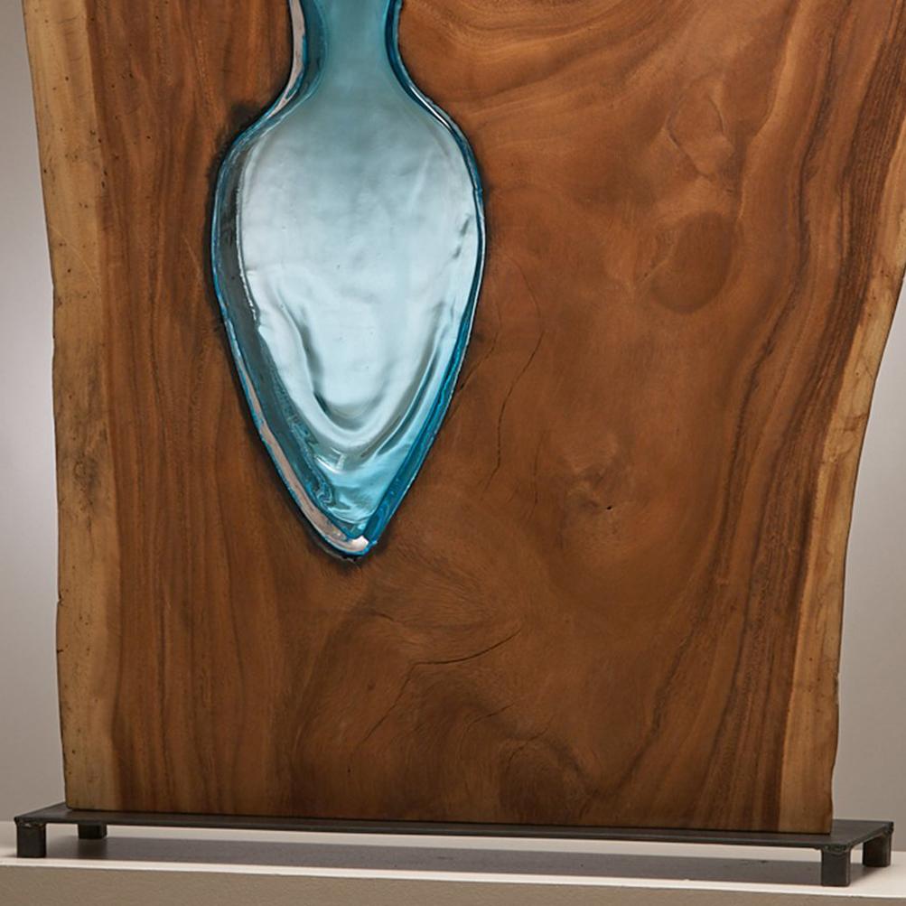 Live Edge Tropical Parota wood with Hand Blown Amphora in Aqua Coloured Glass. 
This is a Large One of a Kind Sculpture.
This is a Functional Sculpture and can be used for Flowers 
The Glass is Blown Directly into the Wood then Cut and Polished.