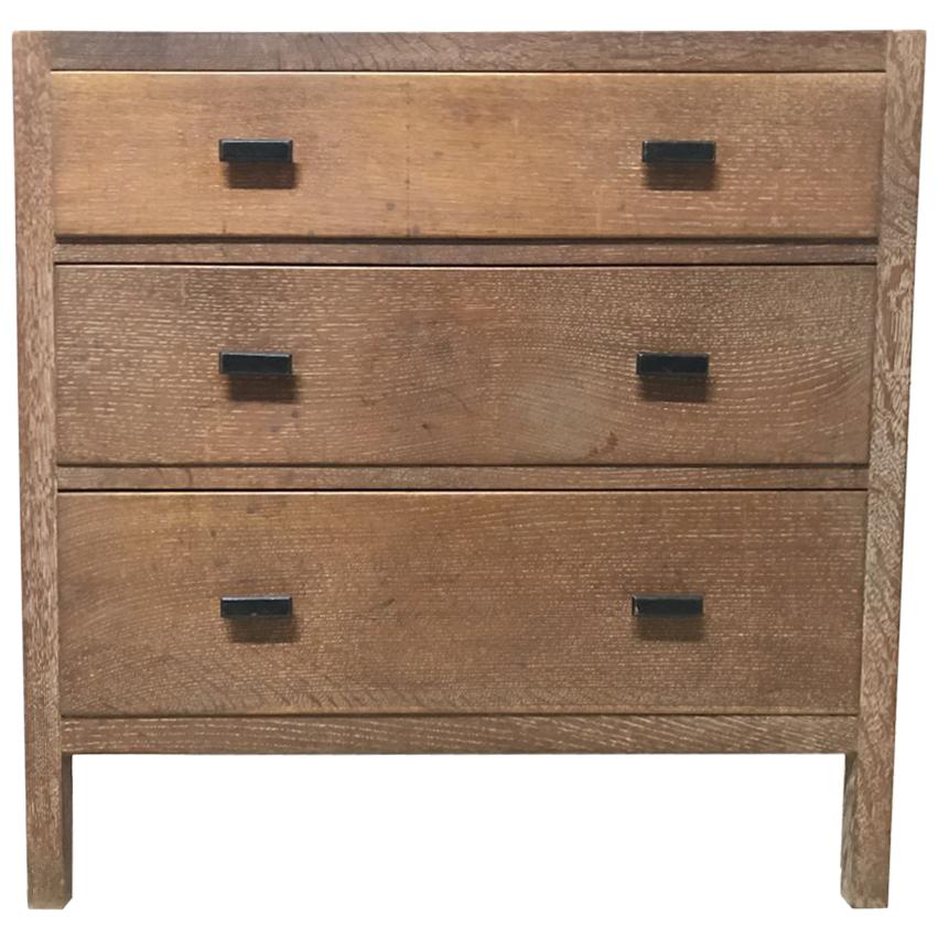 Heals Attributed a Limed Oak Petite Chest of Three Drawers with Ebonized Handles