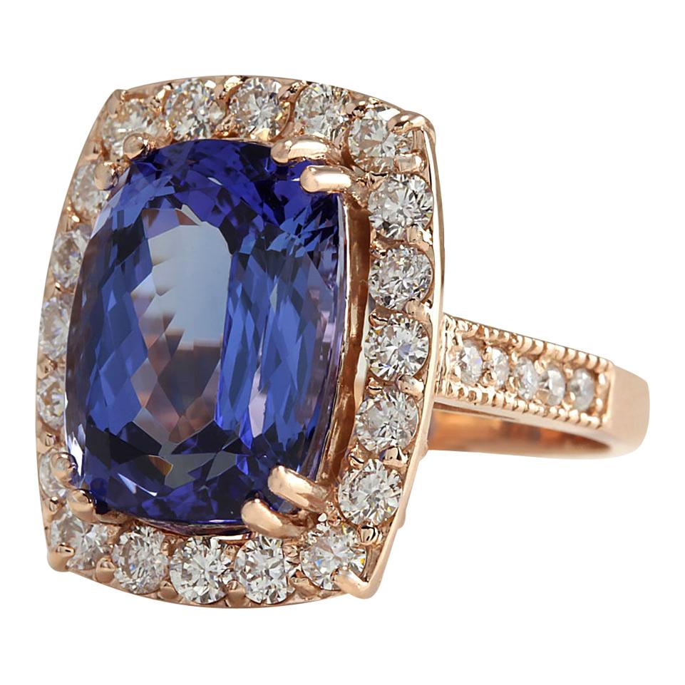 Indulge in opulent beauty with this stunning Tanzanite and Diamond Ring, meticulously crafted in luxurious 14K rose gold. The focal point of this masterpiece is a captivating 11.23 carat Tanzanite, measuring 14.00x10.00 mm and emanating exquisite