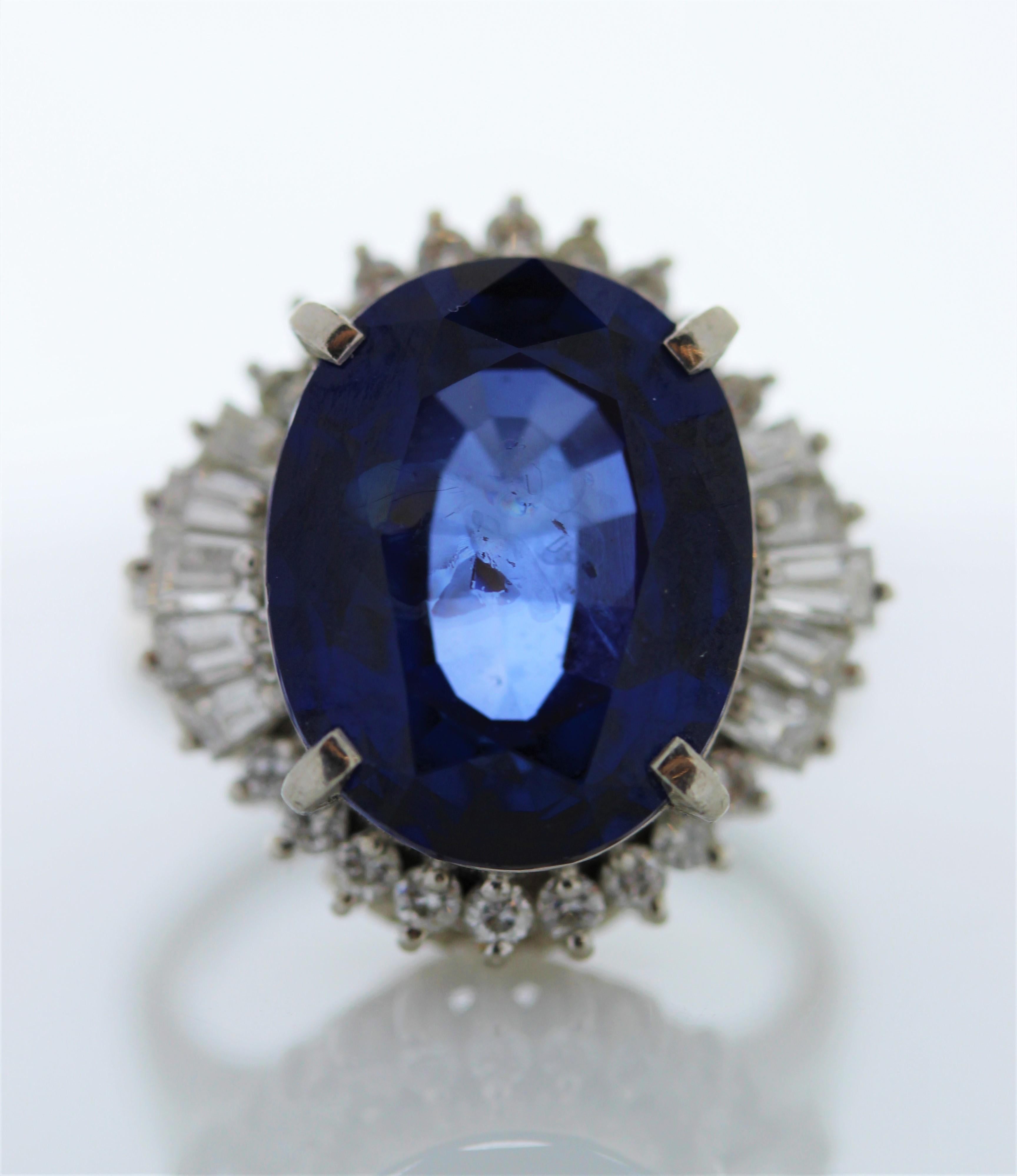 A ring fit for a queen! Your eye will be drawn magnetically to the 11.24 carats royal blue sapphire that is surrounded by a dazzling halo of round brilliant diamonds. The sapphire is from Sri Lanka. The color is royal blue; the luster & clarity are