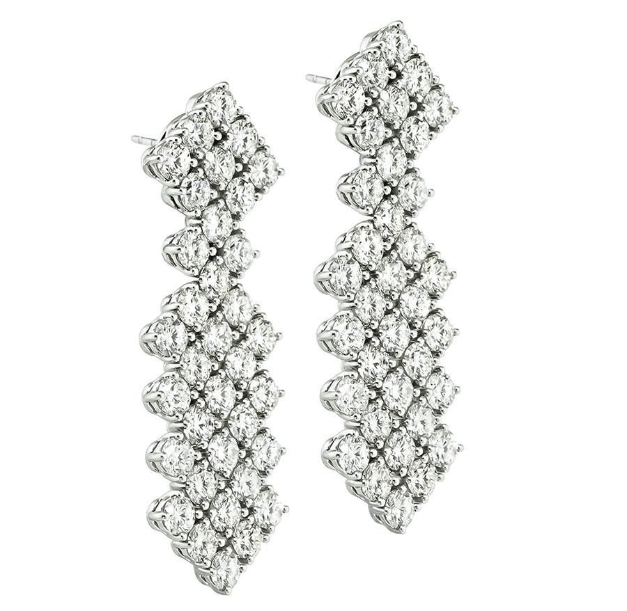 This is an amazing pair of 18k white gold earrings. The earrings feature sparkling round cut diamonds that weigh approximately 11.24ct. The color of these diamonds is F-G with VS2-SI1 clarity. The earrings measure 45mm by 14.5mm and weigh 19.5