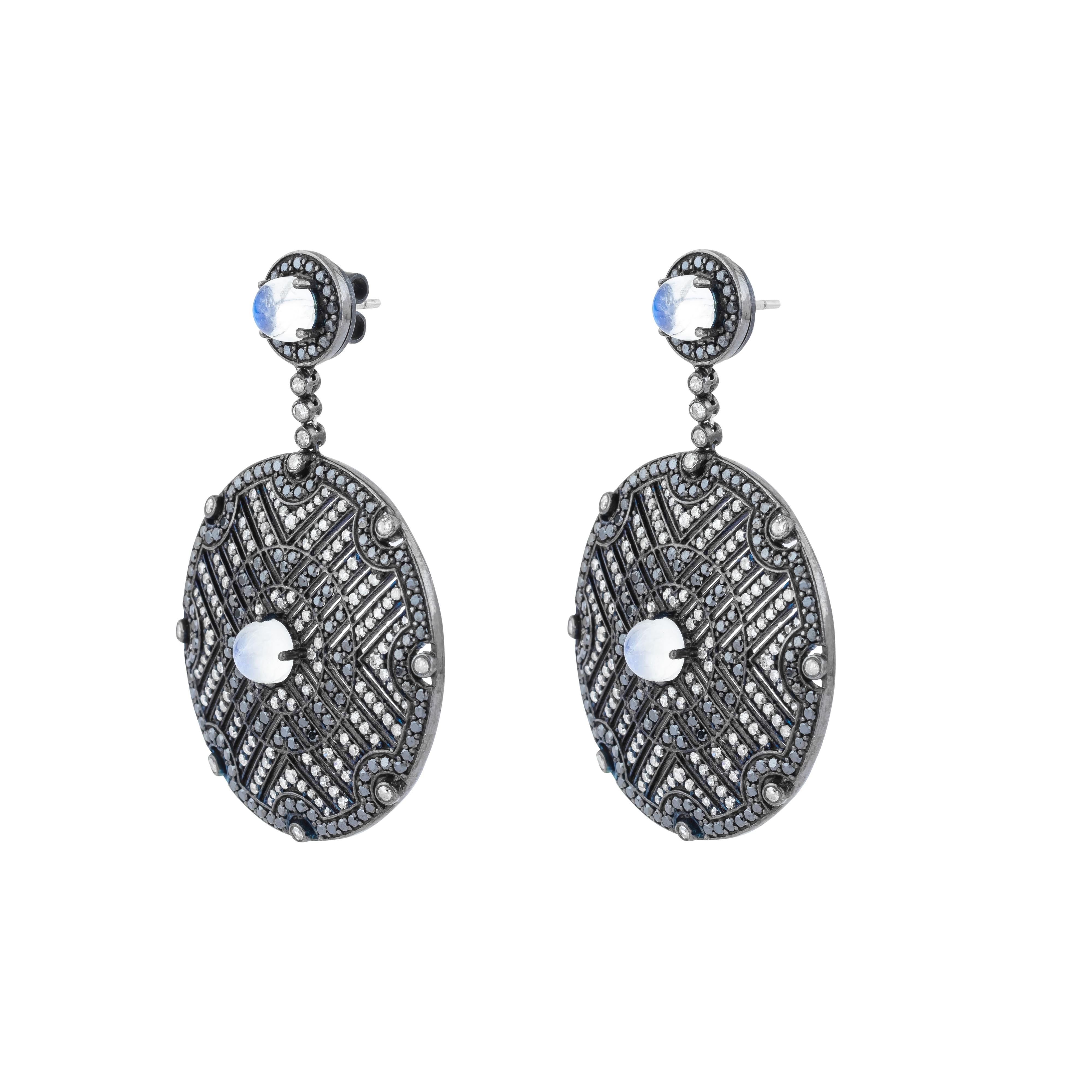 Delicately crafted with an exquisite balance of luminosity and contrast, the 11.25 Carat Diamond, Black Diamond, and Moonstone Drop Earrings offer an unparalleled design that captivates with every detail. Each earring is a blend of radiant