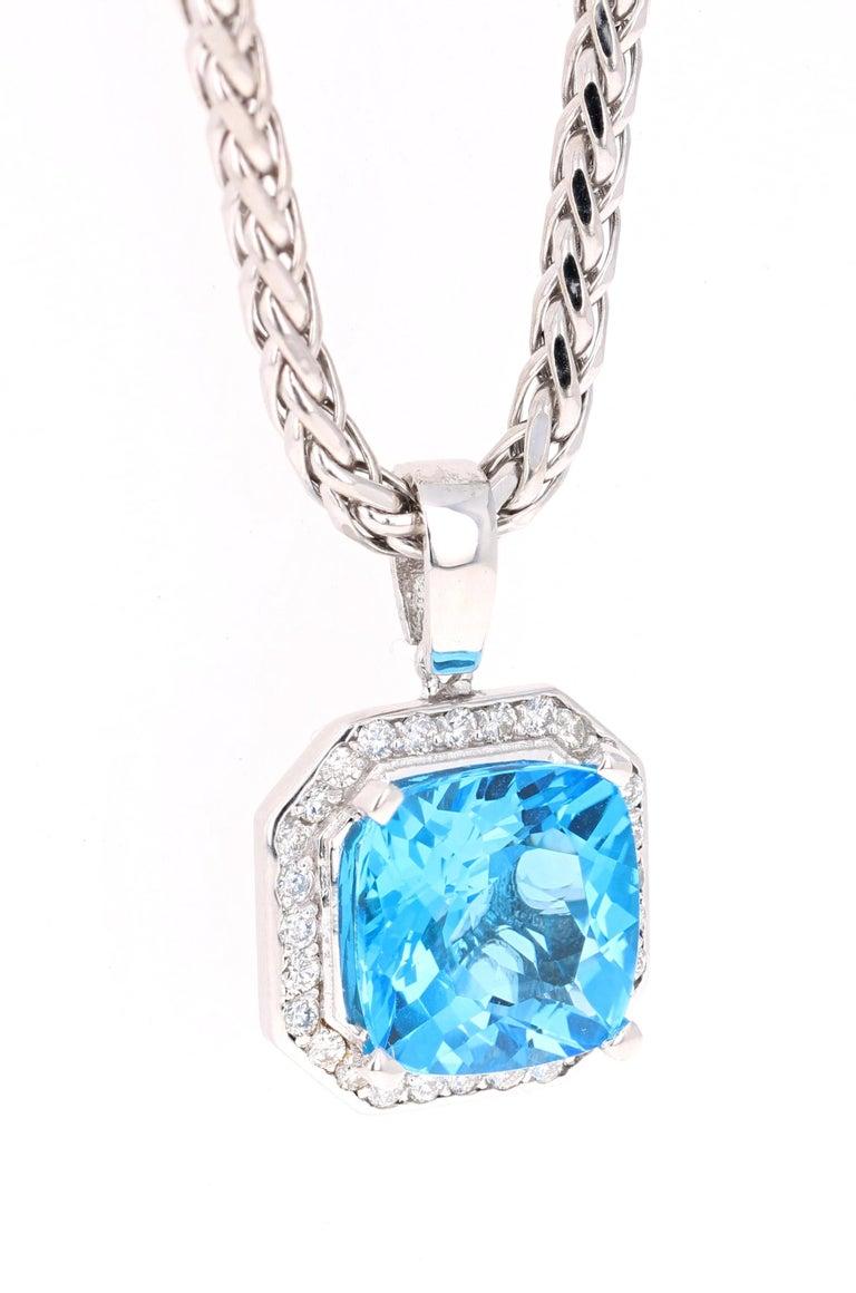 The pendant has a beautiful Cushion Cut Blue Topaz in the center which weighs 10.61 carats.  The Pendant is surrounded by 28 Round Cut Diamonds that weigh 0.65 carats. The total carat weight of the pendant is 11.26 carats.  Set in 14 Karat White