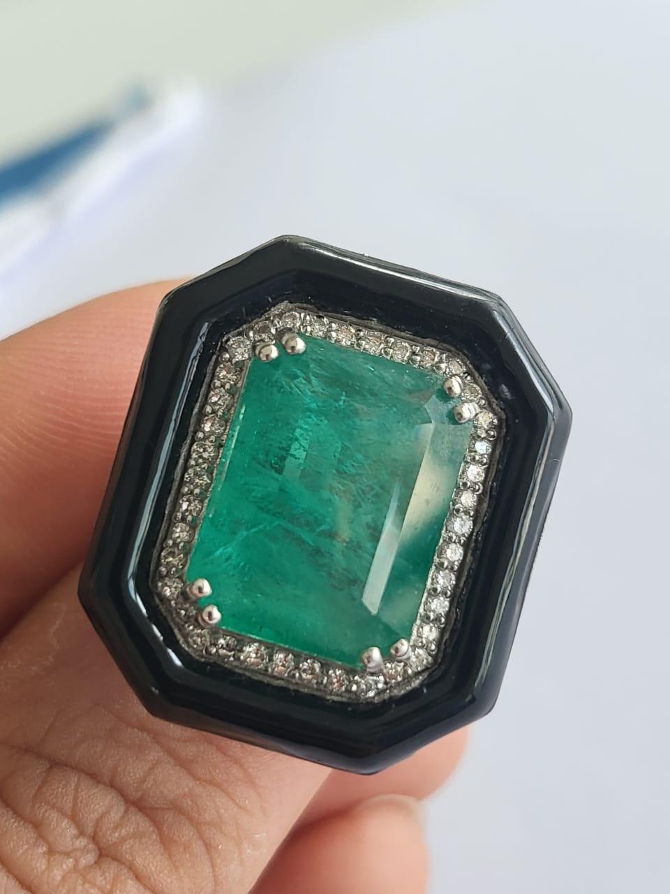 A very gorgeous and beautiful, Emerald & Black Enamel Cocktail / Engagement Ring set in 18K Gold & Diamonds. The weight of the Emerald is 11.2 carats. The Emerald is completely natural, without any treatment & is of Zambian origin. The weight of the