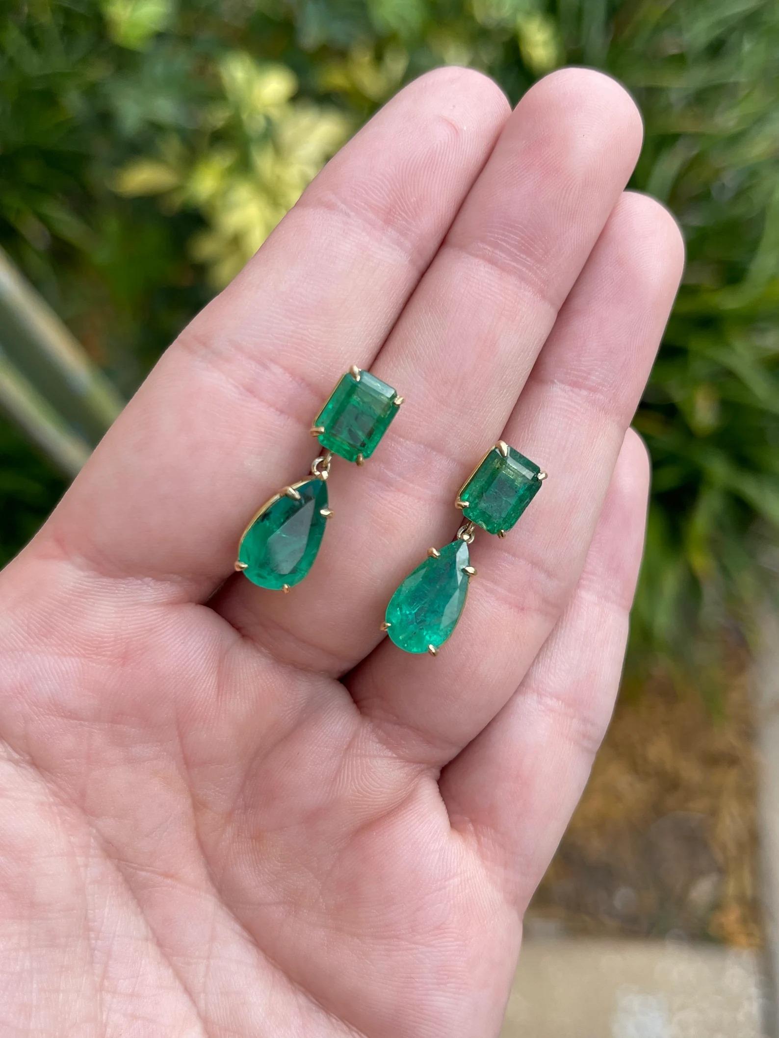 Drool over these fascinating natural rare genuine dark green emerald dangle statement 18K earrings. Two stunning oval-cut emeralds weighing 3.76tcw showcase a lustrous rich dark green color, accented by large 6.02tcw teardrop emeralds that dangle