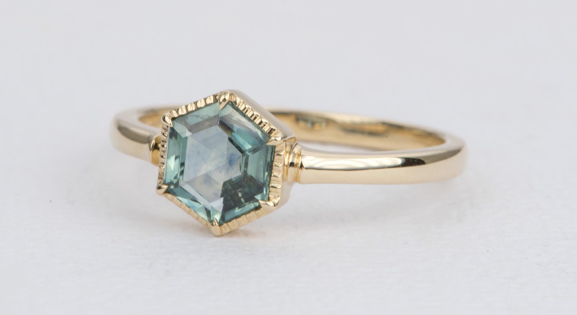 ♥  This blue-green Montana sapphire is secured with six small pointy prongs on each corner.
♥  Surrounded by a milgrain halo, this solitaire sapphire is set on 14K yellow gold.

♥  US Size 6.5 (Free resizing)
♥  Band width: 1.85mm
♥  Material: 14K