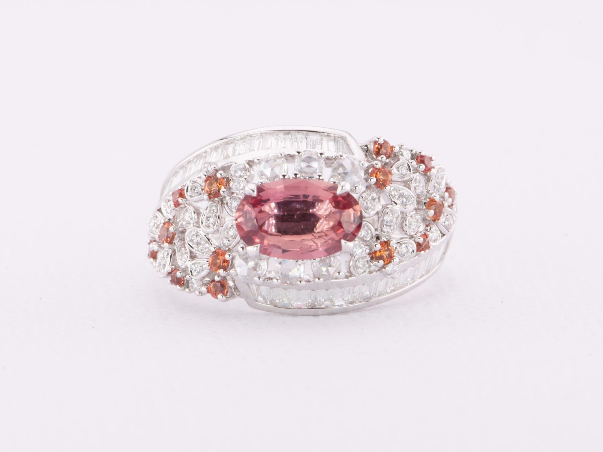 This stunning 1.12ct Padparadscha Sapphire and Diamond Ring in luxurious 18K White Gold will make your dreams come true. With a unique floral cluster design and a rare unheated sapphire, this elegant piece is sure to take your breath away. Shine
