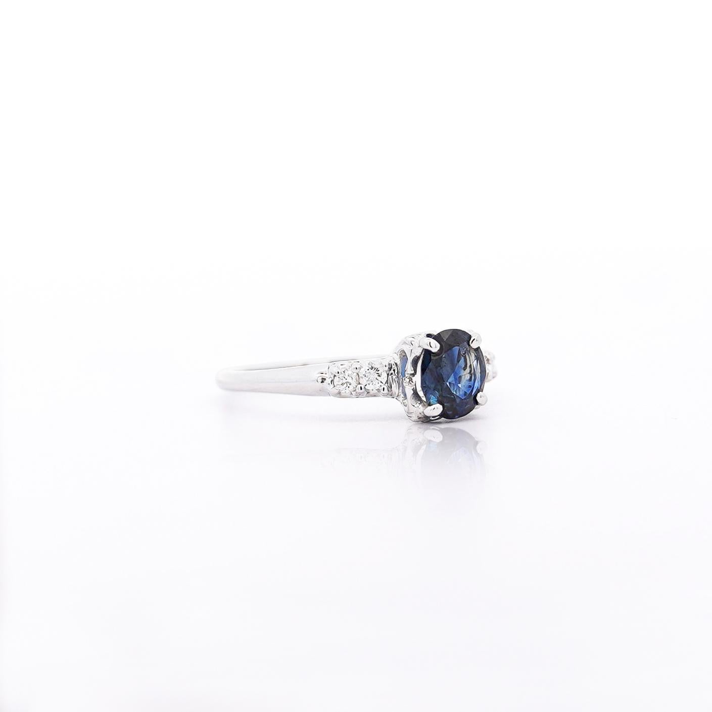 Vintage 1.13-carat sapphire takes center stage in this 14K white gold ring, accented by natural diamonds for the perfect balance of elegance and brilliance.

Details:
Item Type: Engagement Ring
Metal: 14K White Gold
Size: 8 1/2 (adjustable)
Weight: