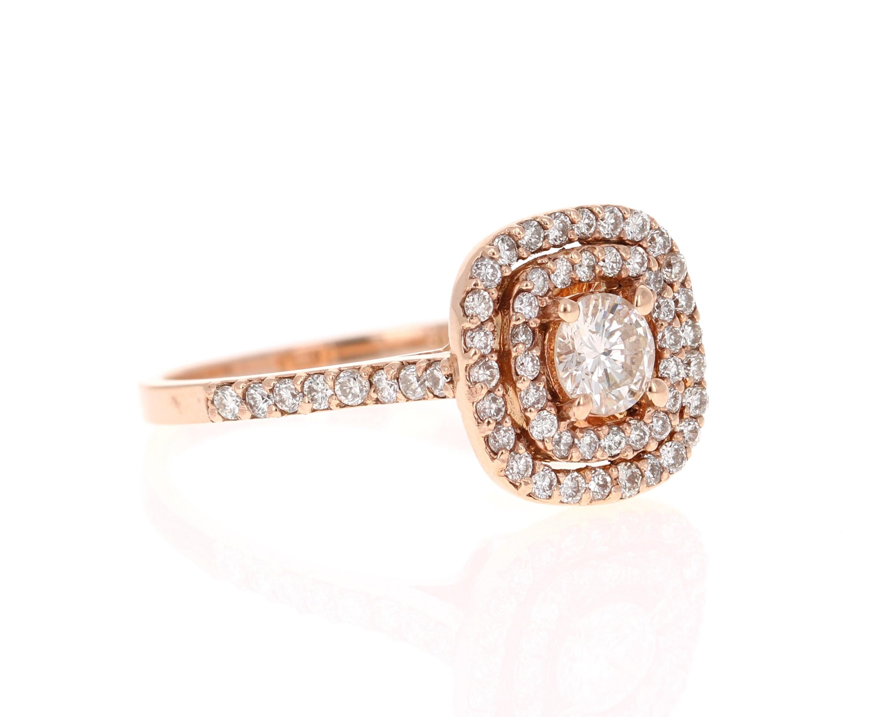 The center round cut diamond weighs 0.43 Carats (Clarity: SI3, Color: I) and is surrounded by 65 round cut diamonds that weigh 0.70 Carats (Clarity: VS, Color: H) The Total Carat Weight of the ring is 1.13 Carats. 

Set in 14 Karat Rose Gold and