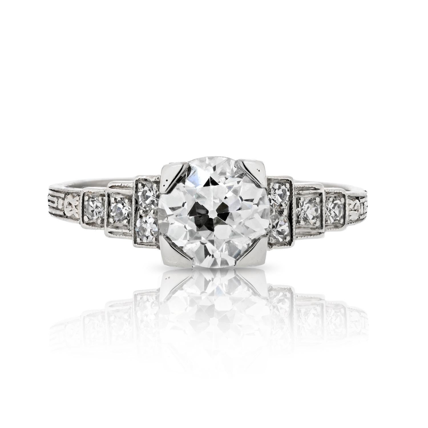 Step into a world of timeless romance with this enchanting 1.13-carat Old European Cut Diamond engagement ring. The captivating center stone, a vintage delight, boasts a gentle I color that exudes warmth and a brilliant VS2 clarity that captures