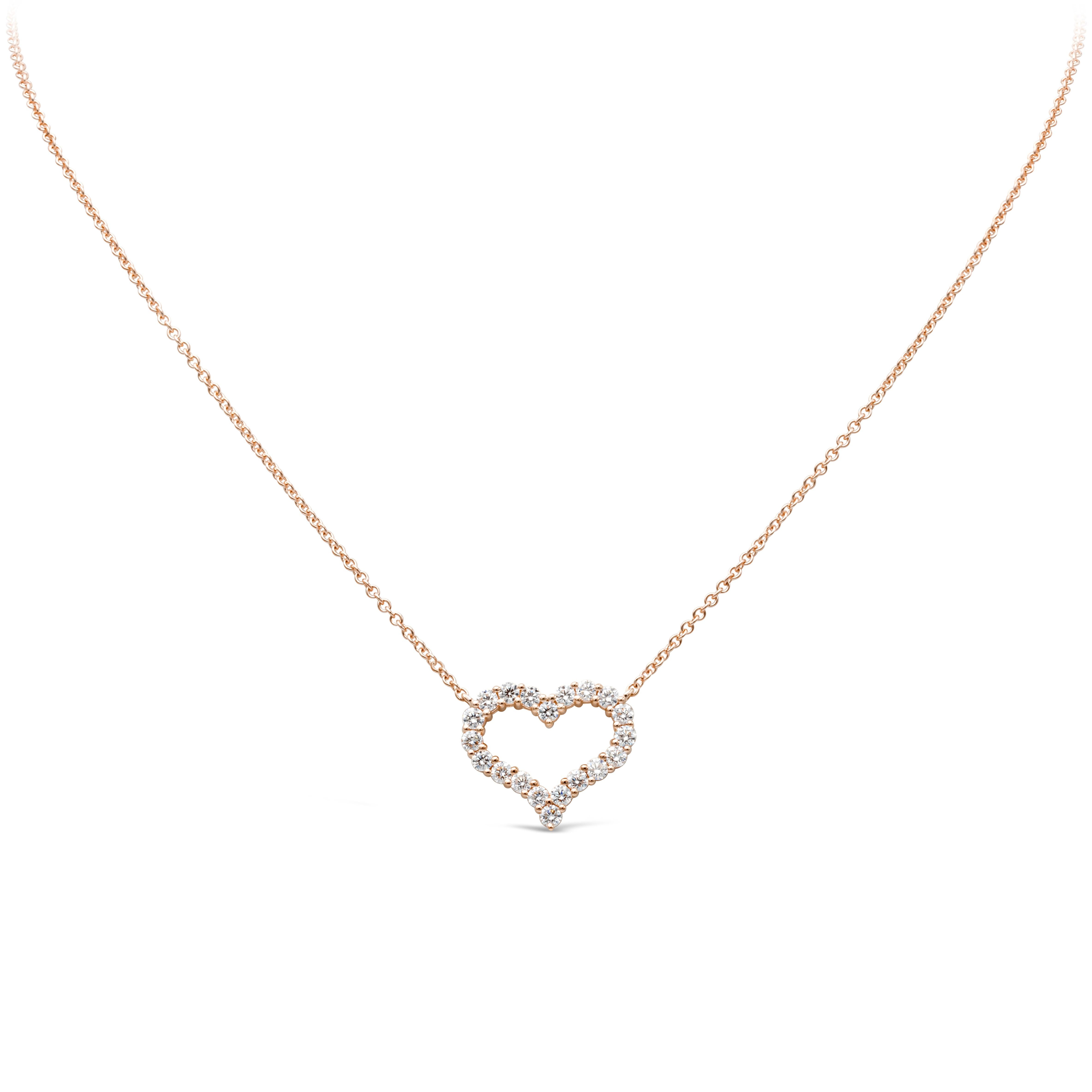 A simple and unique pendant necklace showcasing a row of round brilliant diamonds weighing 1.13 carats total, F color and VS/SI1 in clarity. Set in an open-work heart shape mounting made in 14K rose gold and shared prong setting. Suspended on an