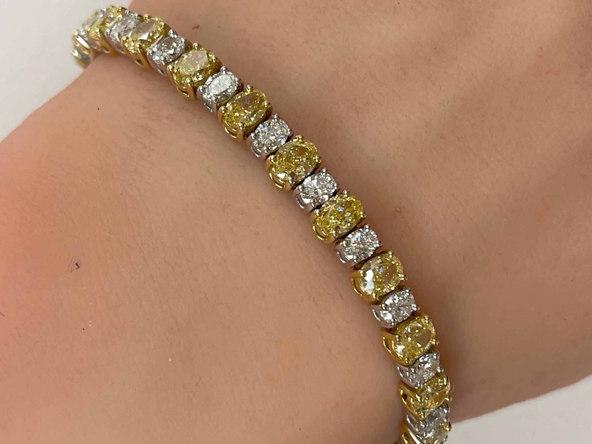 Alternating Fancy Yellow & Oval  Diamond Tennis Bracelet in 18K Two Tone Gold. This tennis bracelet has twenty-four Fancy Yellow diamonds and twenty-four Oval diamonds in F color, VS clarity with an approximately 11.30 carats in total.

