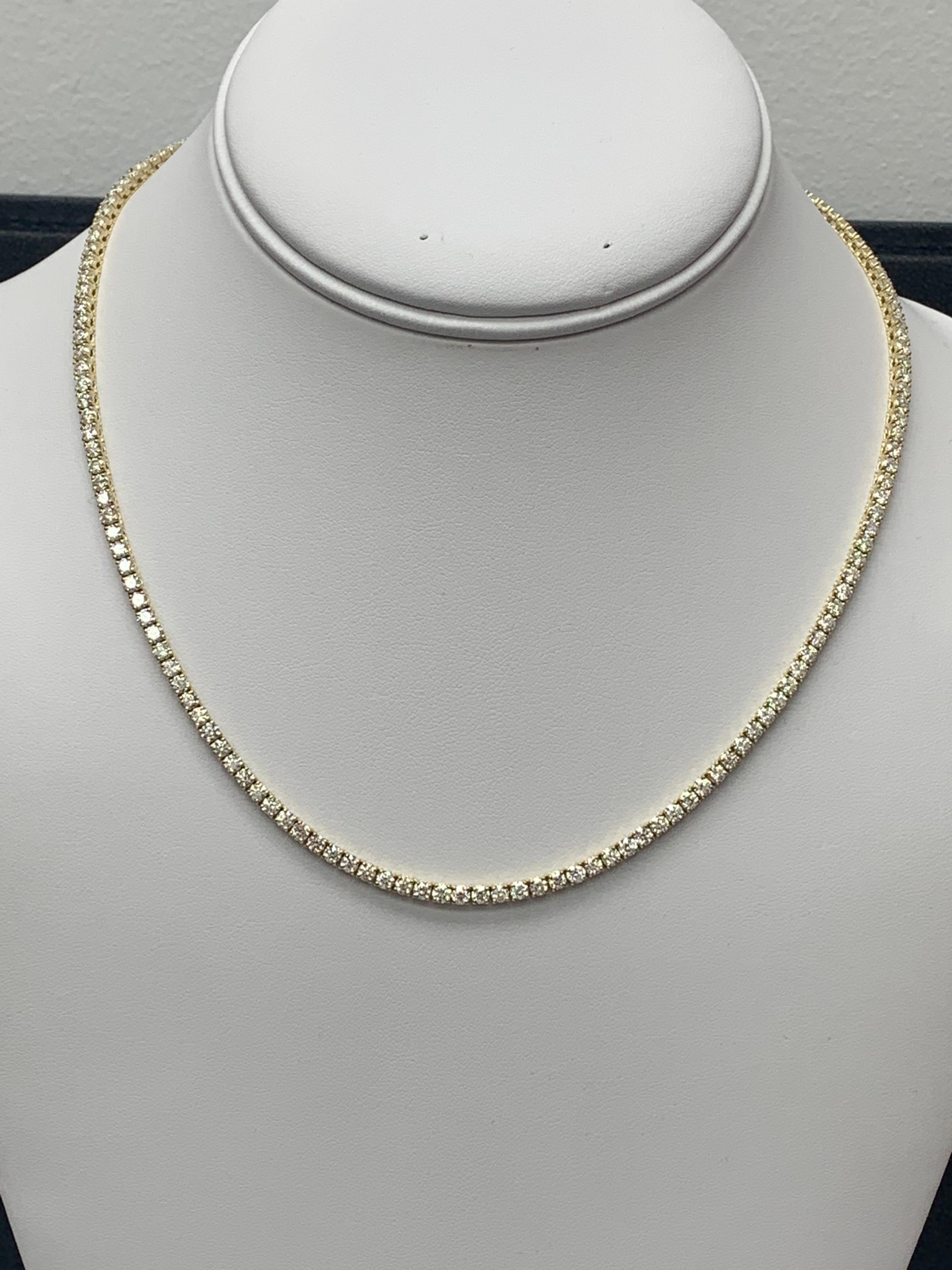 A brilliant and classic piece showcasing a line of round diamonds set in 14K Yellow Gold. 156 diamonds in this necklace are brilliant round cut and weigh 11.31 carats in total. 16 inches in length.