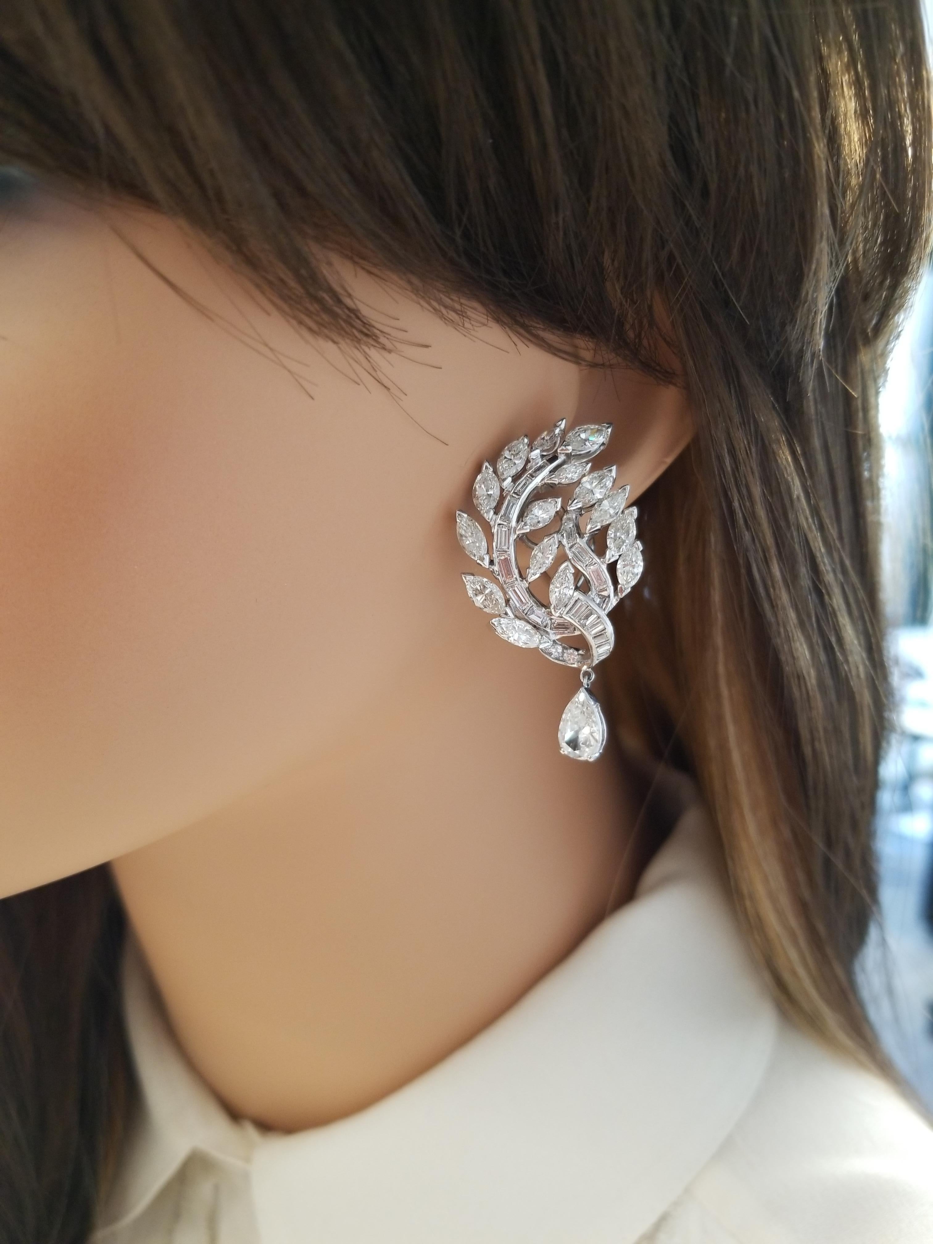 A total of 72 baguette, marquise and round brilliant cut diamonds adorn these incredible earrings totaling 1.35 carats of pure fire and designed with offsetting pear-shaped diamonds that drip on the ends totaling 10.00 carats. Designed in enduring