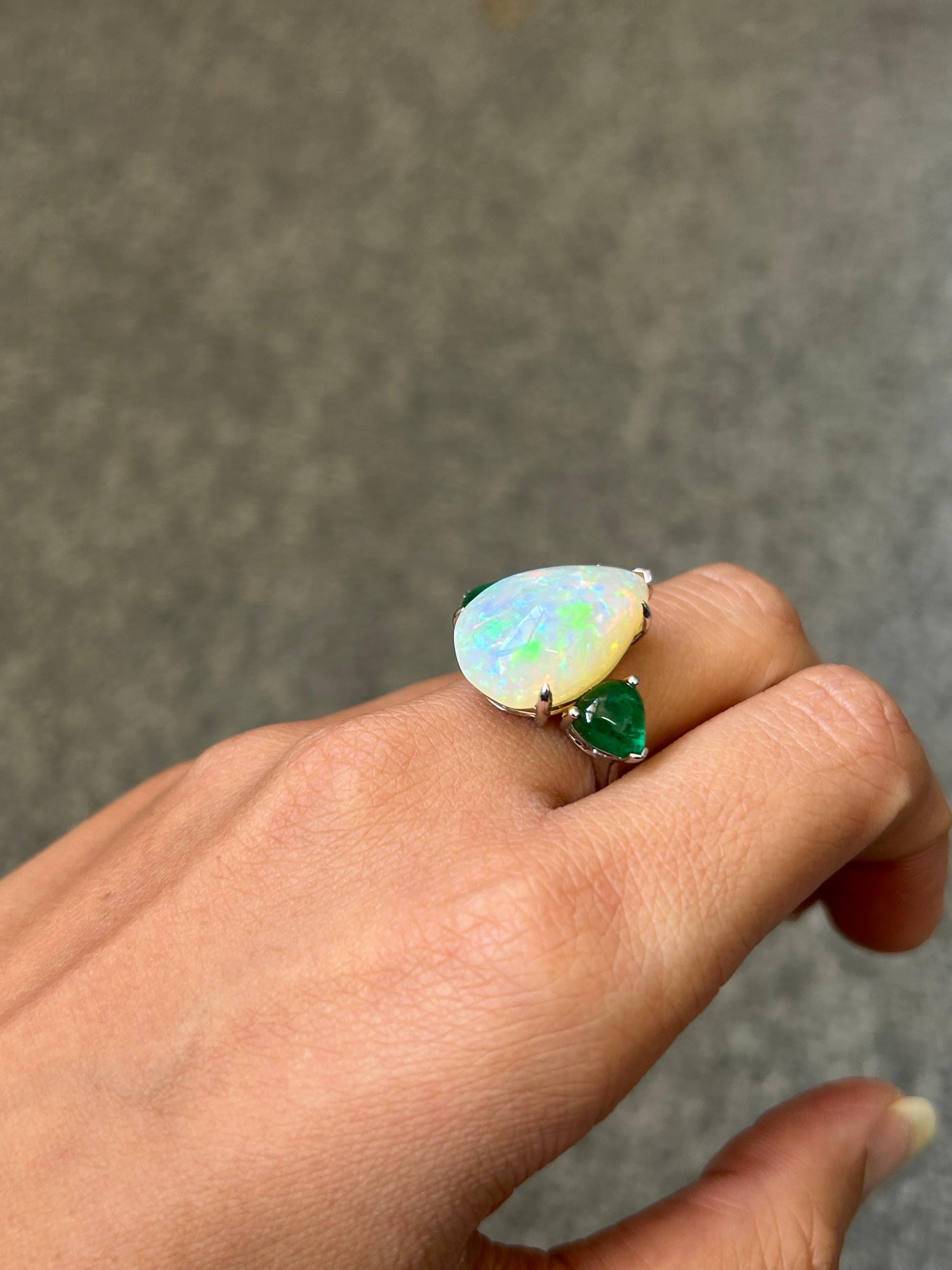 A beautiful combination of 11.36 carat cabochon pear shape Opal and 2.51 carat pear shape cabochon Emerald, set in 18K White Gold. Currently sized at US7, can be resized. 