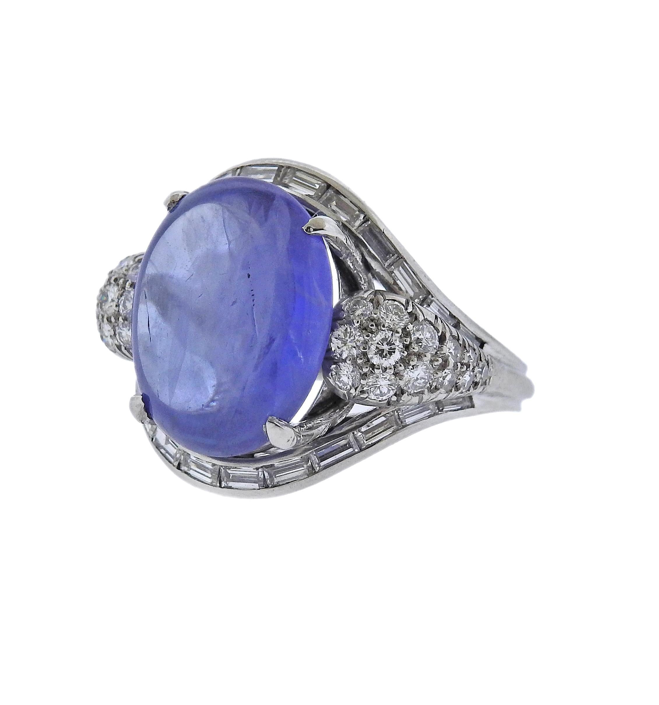 Platinum ring, with center approx. 11.36ct sapphire cabochon, surrounded with approx. 0.70ctw H/VS-Si diamonds. Ring size 6.25 (EU size 52). Top is 18mm wide. Has punchmarks on the shank. Weight  12.2 grams. 