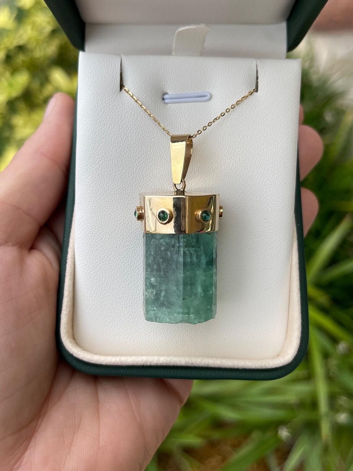 This is an impressive and rare, estimated 113-carat, all-natural Colombian emerald from the Muzo Mines! The rough specimen is semi-transparent, displaying incredible crystal clarity. A medium green color is seen in this stunning piece with the most