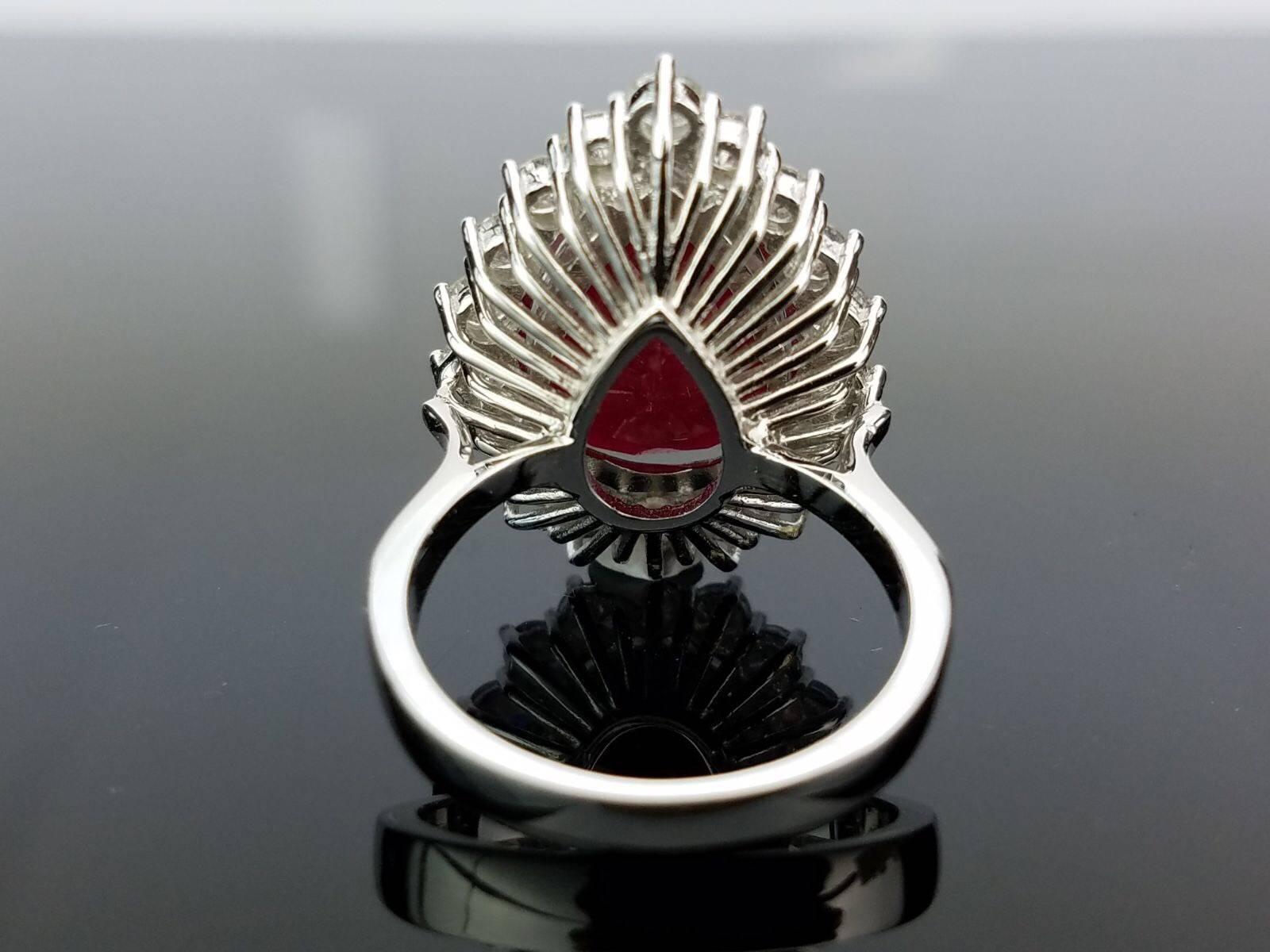 A classic looking African Ruby pear shape ring, surrounded with Diamonds. All set in 18K White Gold.

Stone Details: 
Stone: Ruby
Carat Weight: 11.38 Carats

Diamond Details: 
Total Carat Weight: 1.86 carat
Quality: VS/SI , H/I

Currently a ring