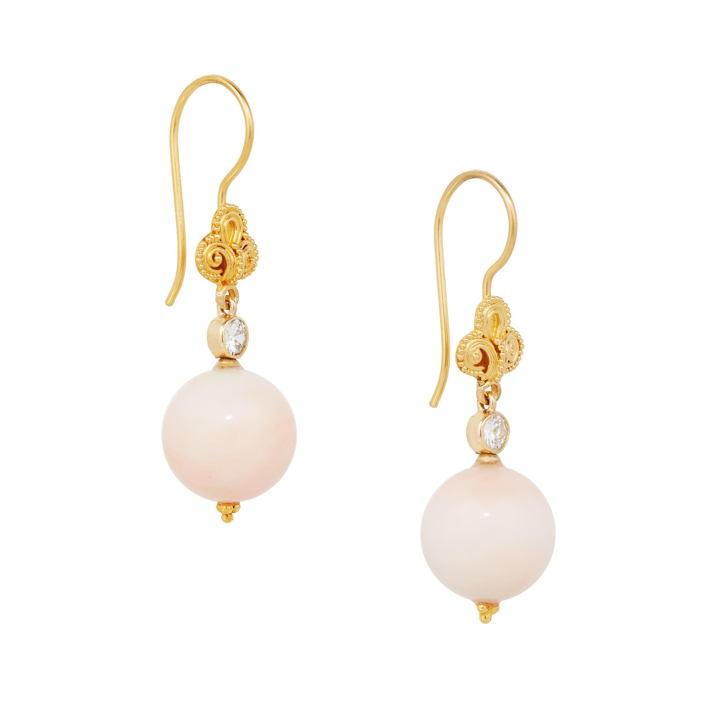 Stunning earrings that were created to feature matched 11.38 mm Vintage Angel Skin Coral.  They are topped with 0.34 Carats of Diamond.  The brushed 18 Karat Yellow Gold with the hand beading gives these earrings an extra luxurious look. 