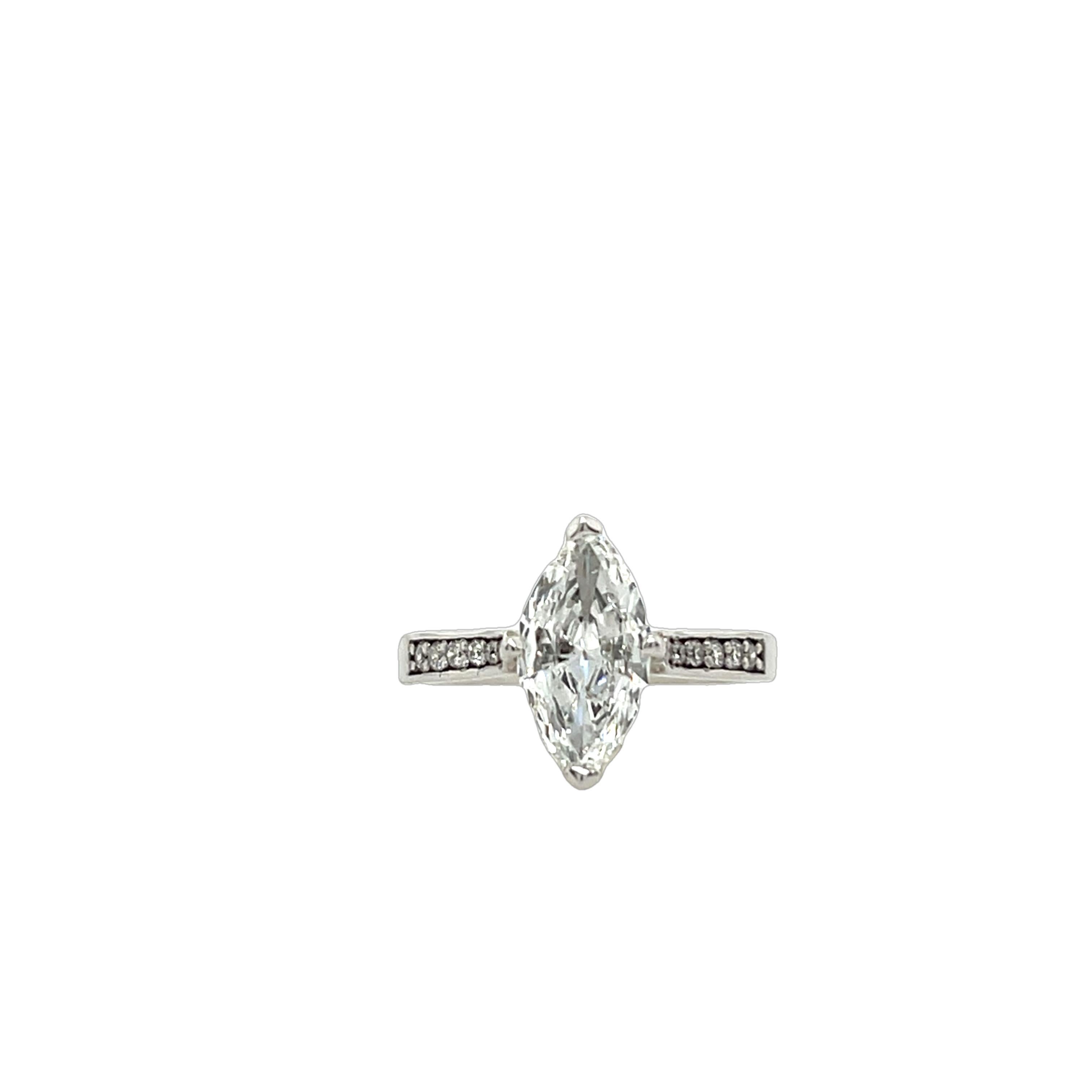 AA stunning marquise-cut diamond weighing 1.13ct 
with small diamonds on the shoulders, 
expertly set in a luxurious 18ct white gold band. 
Total Diamond Weight: 1.13ct & 0.18ct
Diamond Colour: E
Diamond Clarity: VS2
Width of Band: 2.30mm
Width of