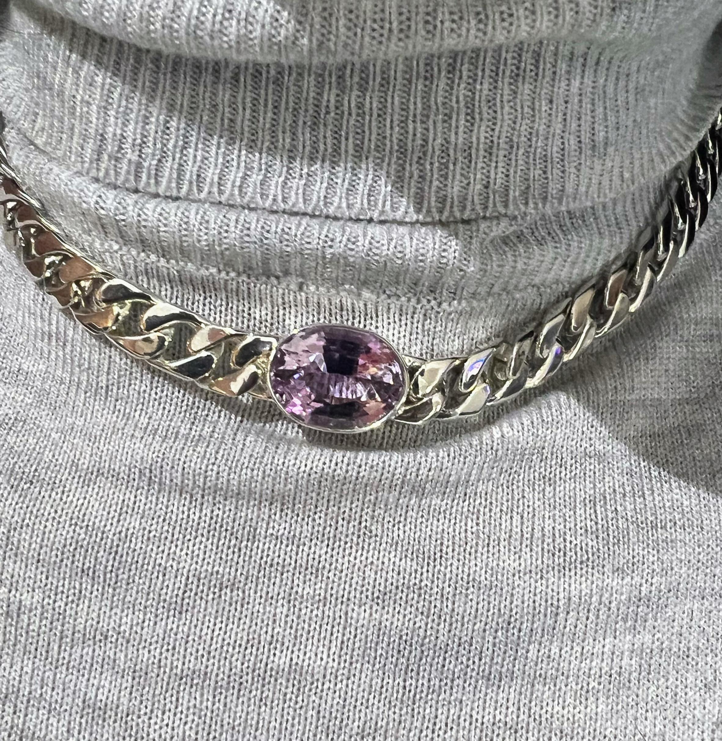 Indulge in the opulence of our 11.3-carat purple amethyst necklace, a true testament to craftsmanship and luxury. The centerpiece, a colossal amethyst measuring 16.4mm x 12.4mm x 9.6mm, is a breathtaking spectacle, its size and color commanding