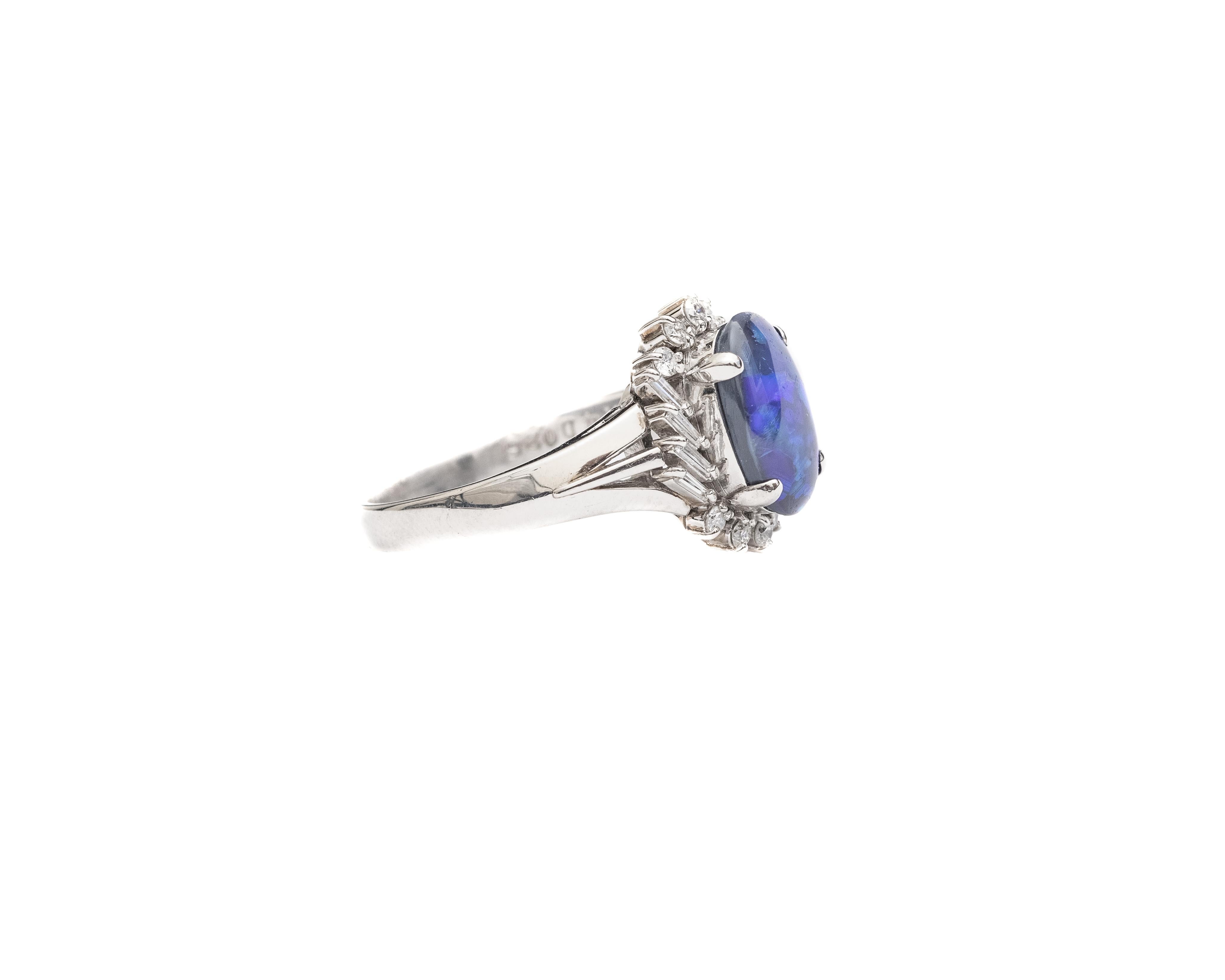 Item Description:
Metal type: Platinum
Weight: 3.6 grams
Size: 5 (resizable)

This beautiful ring features a gorgeous black opal with strong deep blue and green hues visible under different lighting. The opal is 1.14 carat in weight and is 4-prong