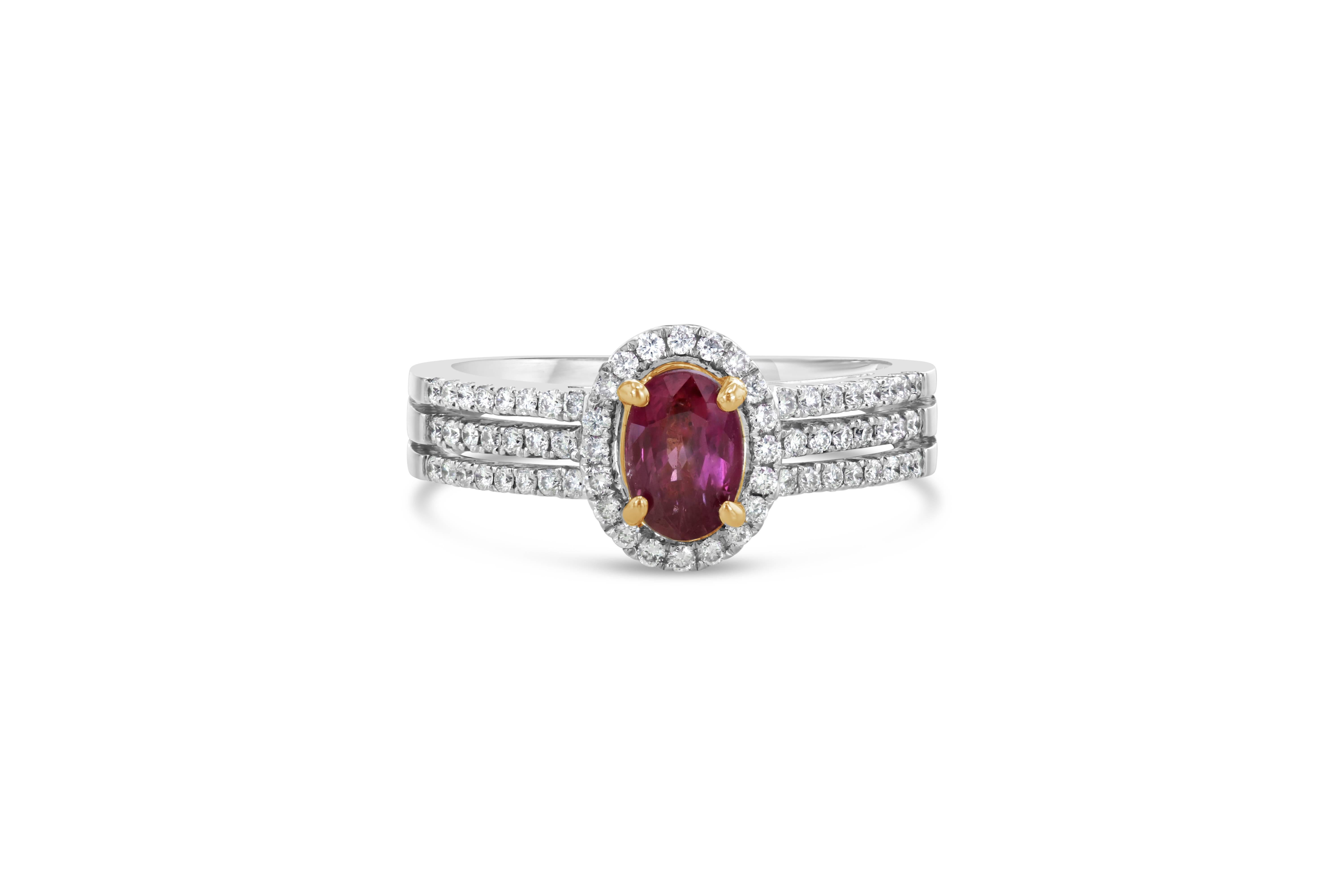 The center stone is a natural 0.81 Carat Ruby from Burma (Myanmar) surrounded by 66 Round Cut Diamonds weighing 0.33 Carats. It is uniquely set in 18K White Gold with beautiful Yellow Gold Prongs holding the Ruby which brings out the color and fire
