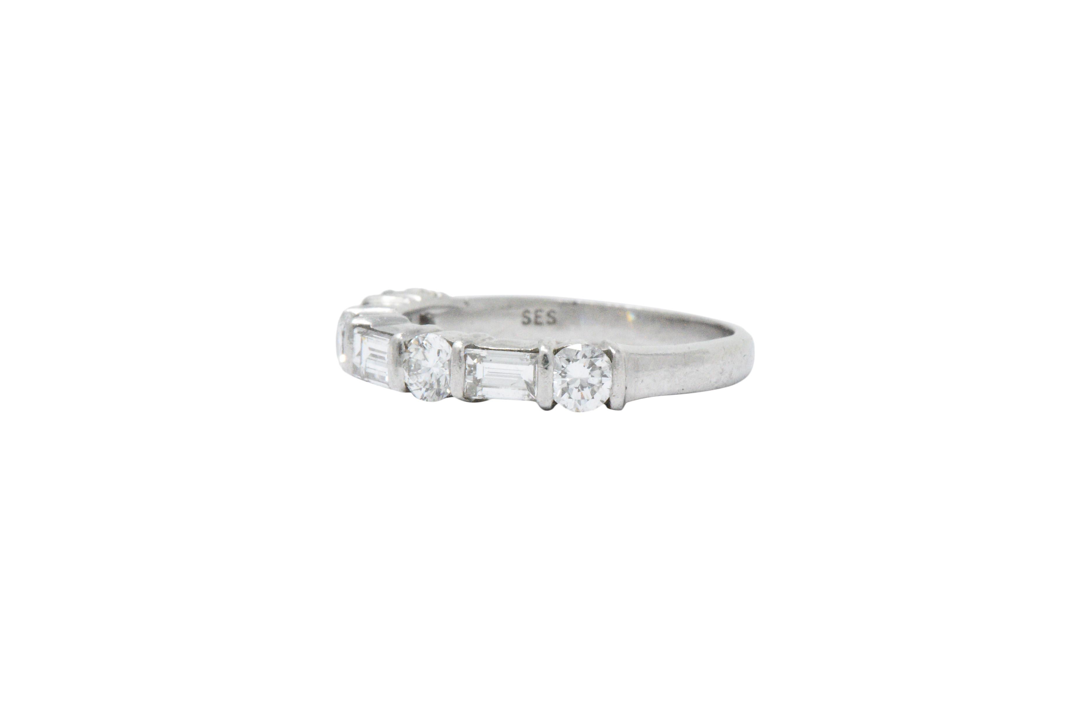 Set to the front with four round brilliant cut diamonds and three straight baguette cut diamonds, set alternating, approximately 1.14 carats total, GHI color and VS to SI clarity 

The diamonds are bar set, giving it a clean, sleek modern look

So