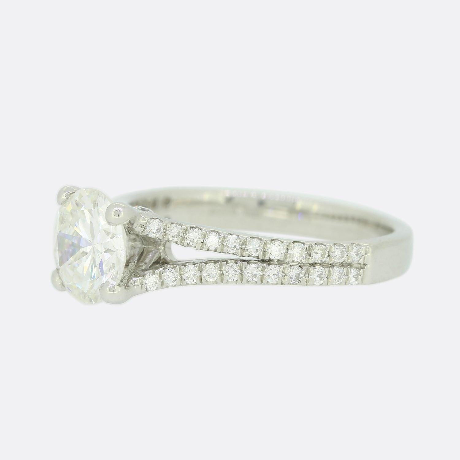 This is a platinum diamond solitaire ring. The focal point of the ring is a stunning round brilliant cut diamond set in a 4 clawed mount. The shoulders of the ring split in 2 and are set with 40 diamonds in total leading up to the centre