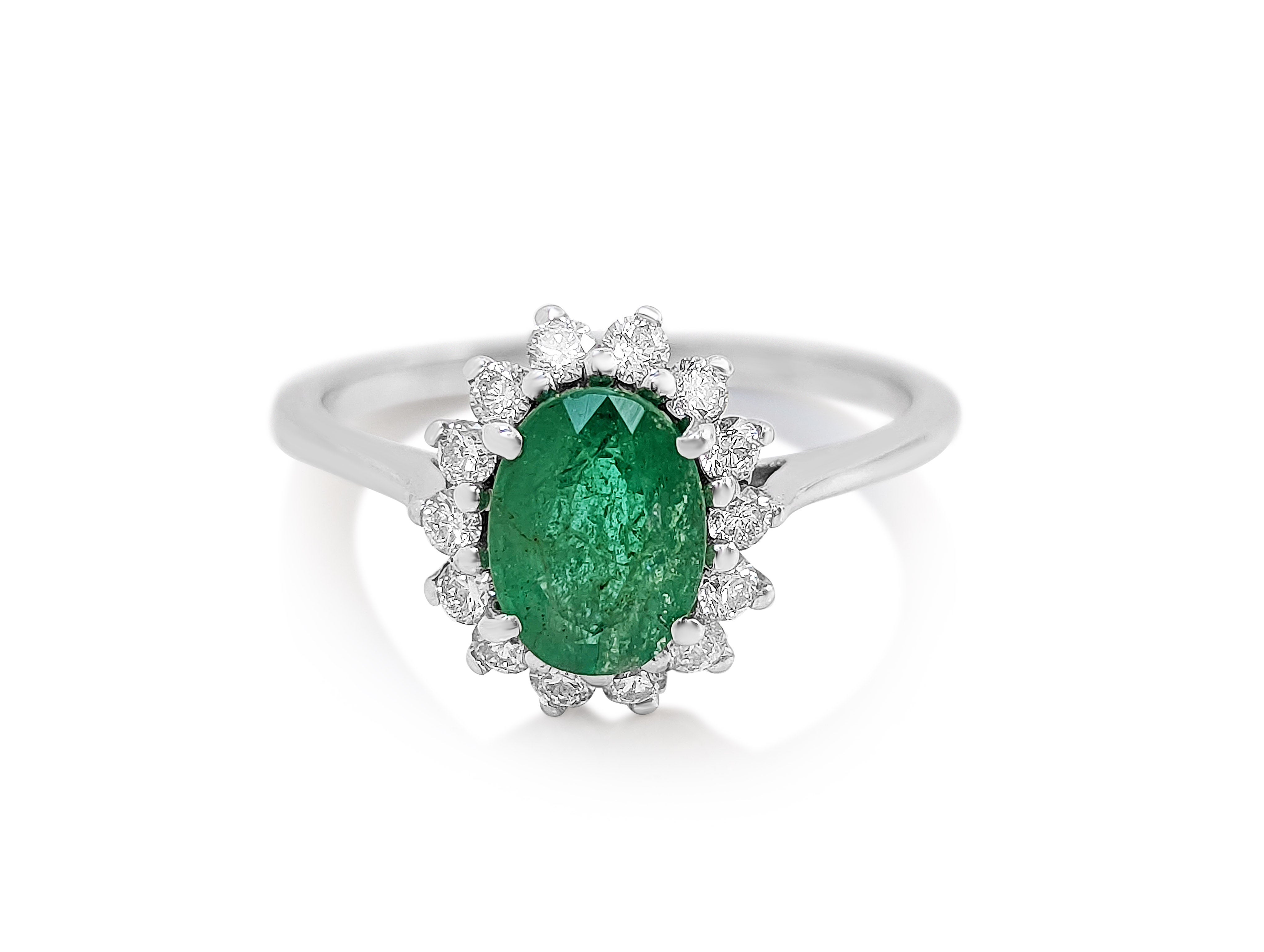 Ring can be sized free of charge prior to shipping out.

Center Stone:
___________
Natural Emerald
Cut: Oval Mixed
Carat: 1.14  ct
Color: Green

Side Stones:
___________
Natural Diamonds
Cut: Round 
Carat: 0.35 tccw / 54 stones
Color: E-H
Clarity:
