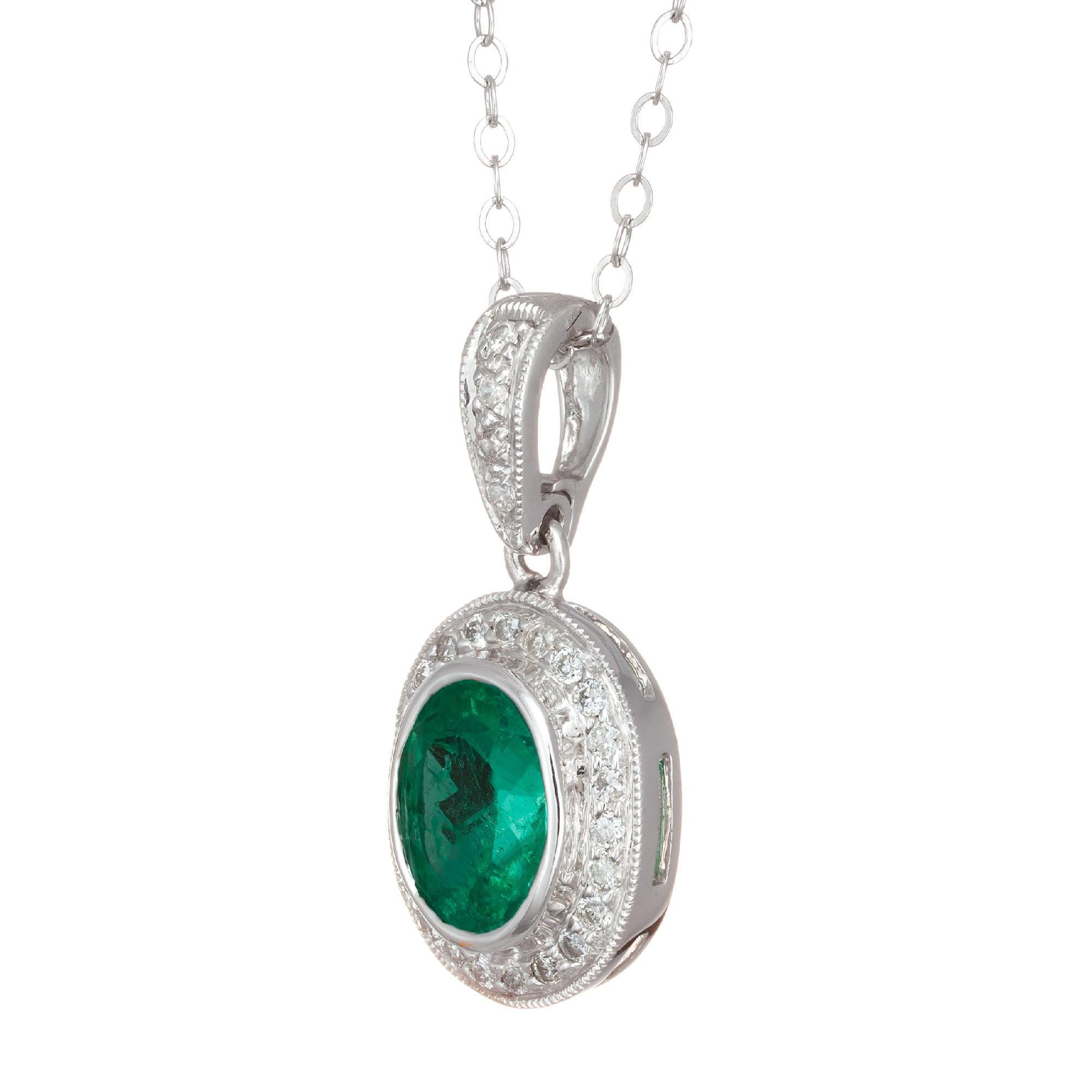 Oval Emerald and diamond halo pendant. 1.14 carat oval emerald with round accent diamonds in 14k white gold.  diamonds.

Emerald oval 8 x 6.5mm, approx. total weight 1.14cts
30 full cut diamonds, approx. total weight .16cts, G, VS
14k White Gold
18
