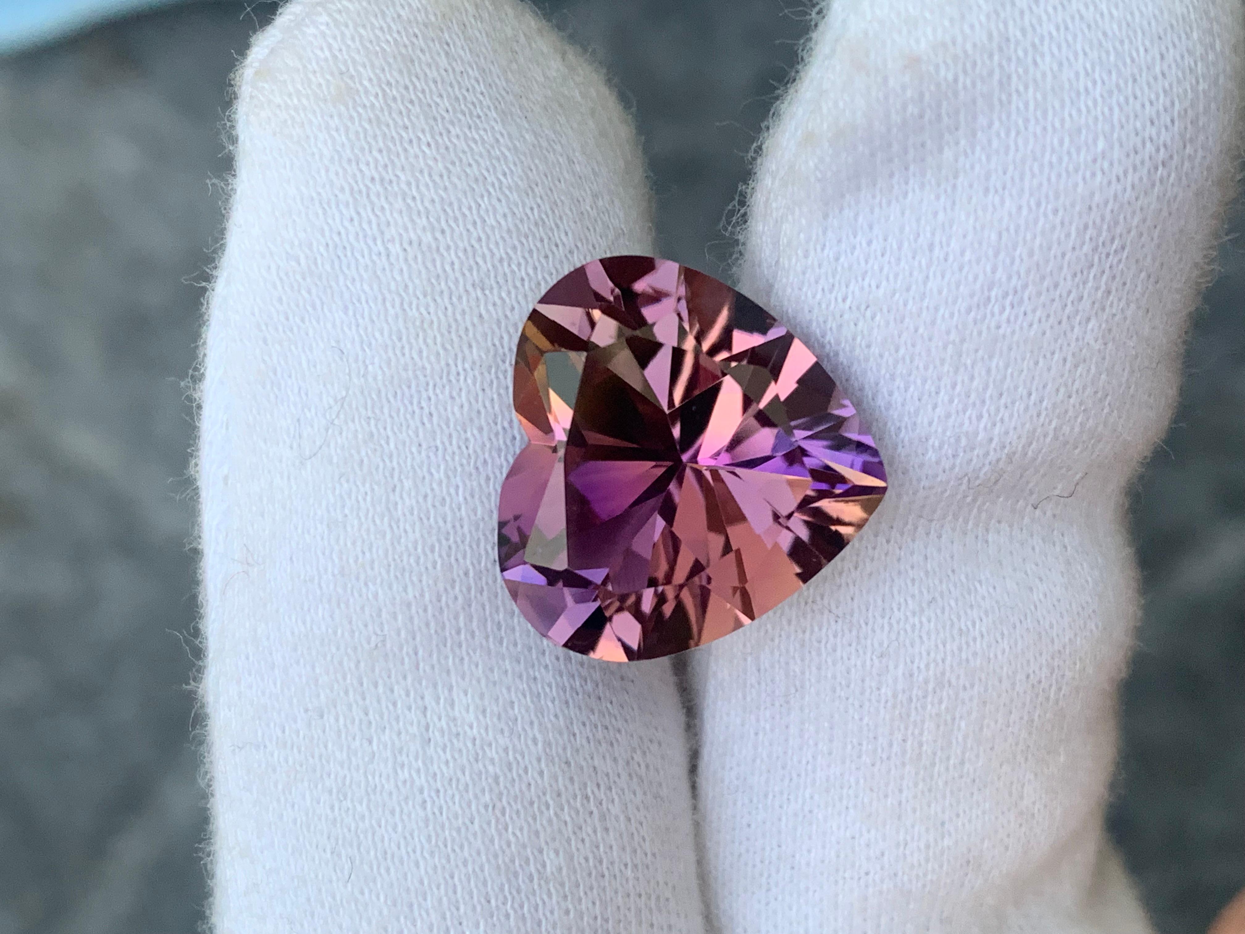 Faceted Ametrine 
Weight: 11.40 Carats
Dimension: 15.6x16.6x9.3 Mm
Origin: Bolivia 
Color: Purple & Yellow
Clarity: Loupe Clean
Certificate: On Demand
Shape: Heart 
For those born in the month of February, you've been graced with amethyst as your