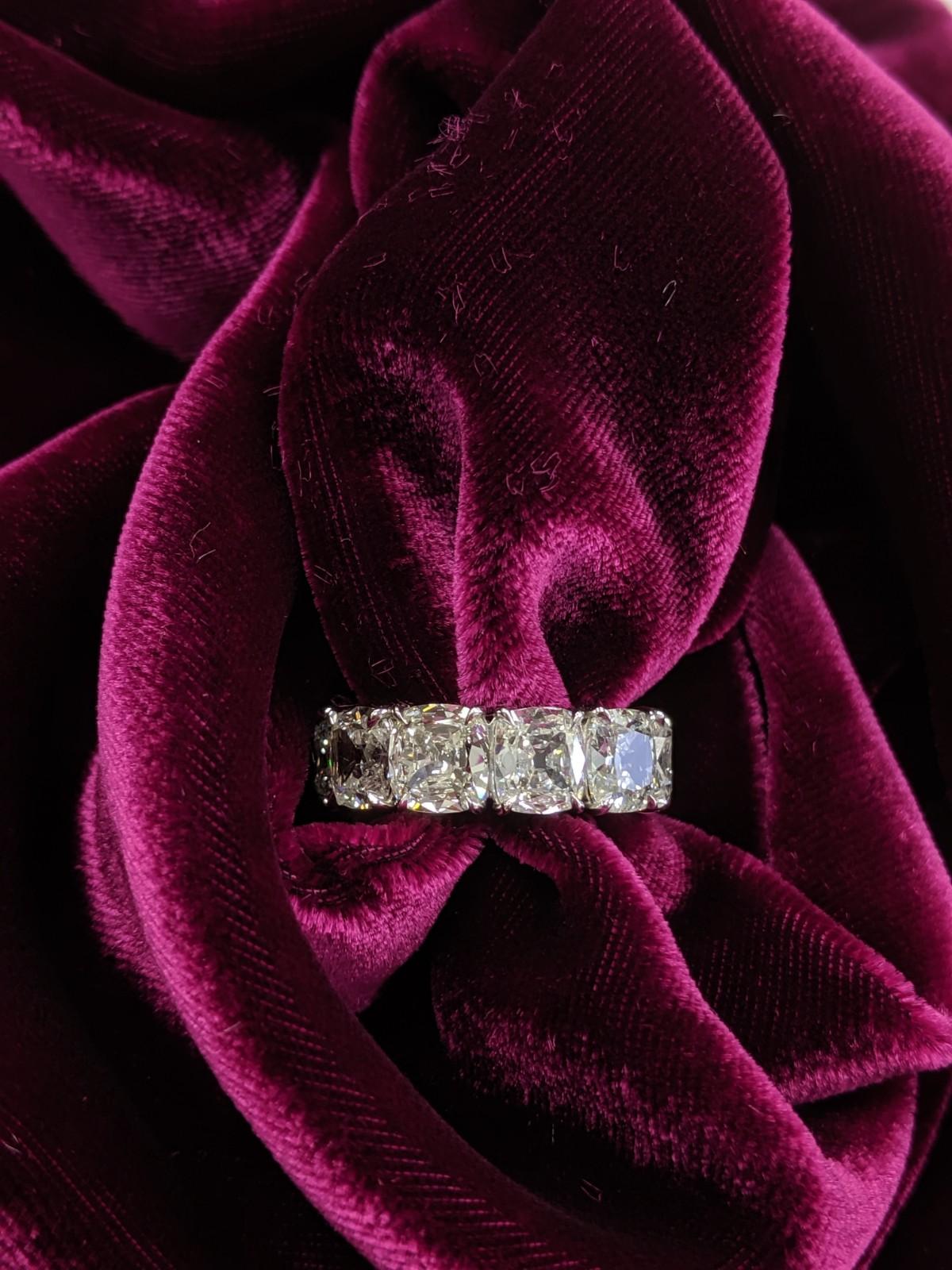 This spectacular 11.42 carat weight cushion cut diamond eternity band is comprised of traditional cushion cut diamonds approximately one carat each D-G color and VS-SI clarity.  Video and GIA grading certficates available upon request.  Each diamond