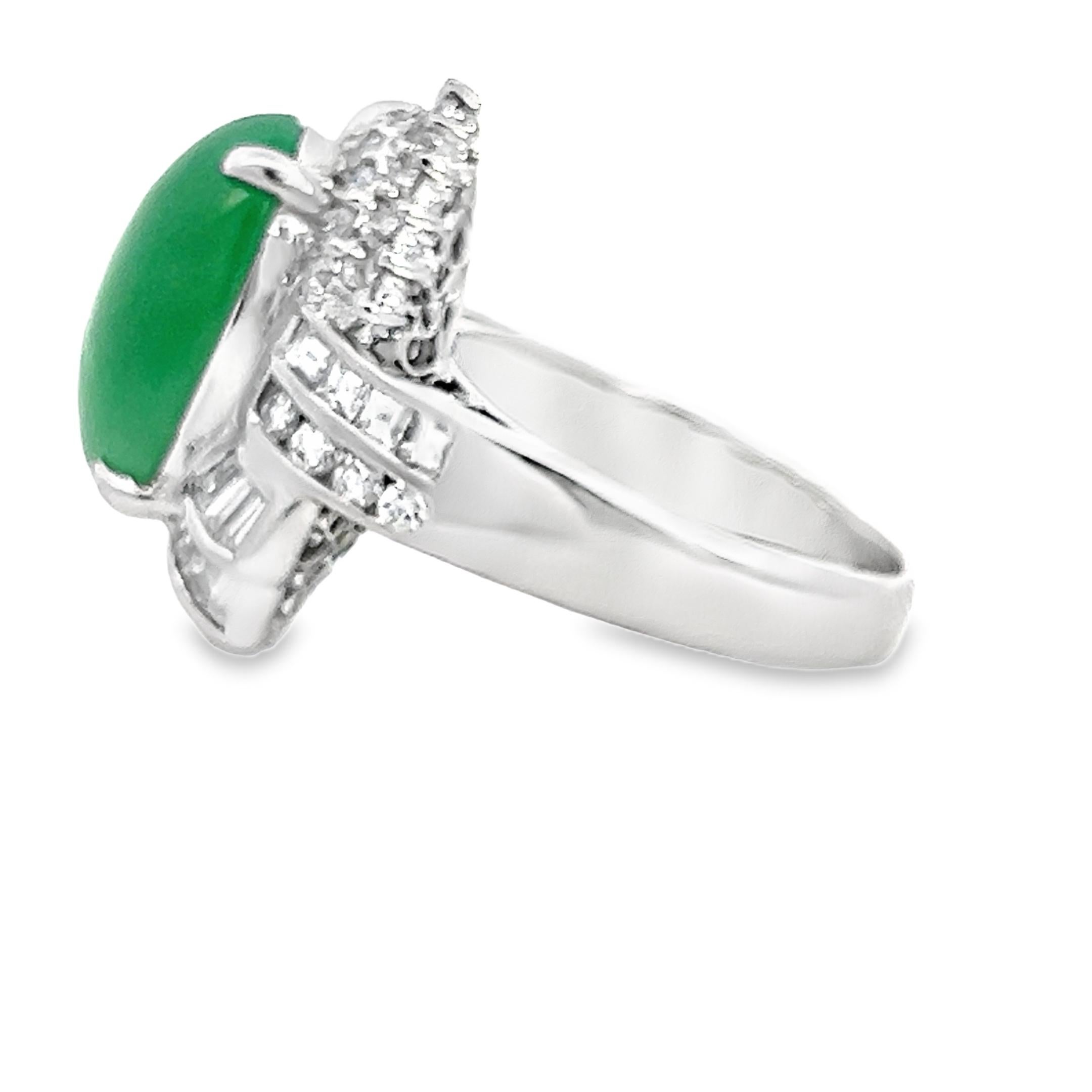 This striking retro cocktail ring features an 11.44-carat natural green jade gemstone set in solid platinum and framed by 1.95 carats of sparkling diamonds. The diamond halo includes carre cuts, round brilliants, and tapered baguettes, offering a