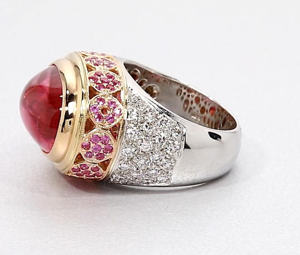 This pretty-in-pink ring is a knock out! It is large and lovely and one-of-a-kind. Made of 18k white, pink and yellow gold. It features an oval pink tourmaline cabochon that is set in an unusual 