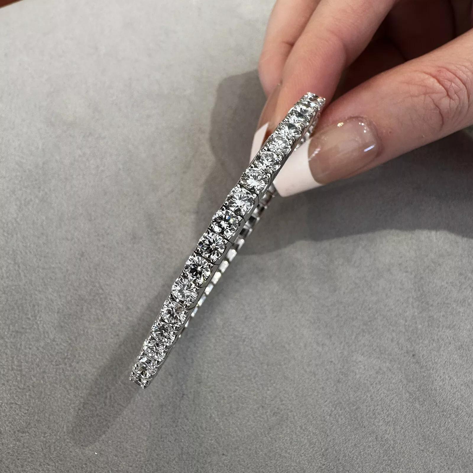 11.45 cttw Diamond Tennis Stretch Bangle Bracelet in 14k White Gold 

Diamond Stretch Tennis Bracelet features 48 Round Brilliant Diamonds set in 14k White Gold in a four-prong stretchable setting.

The average size of each stone is .23 ct.
Total